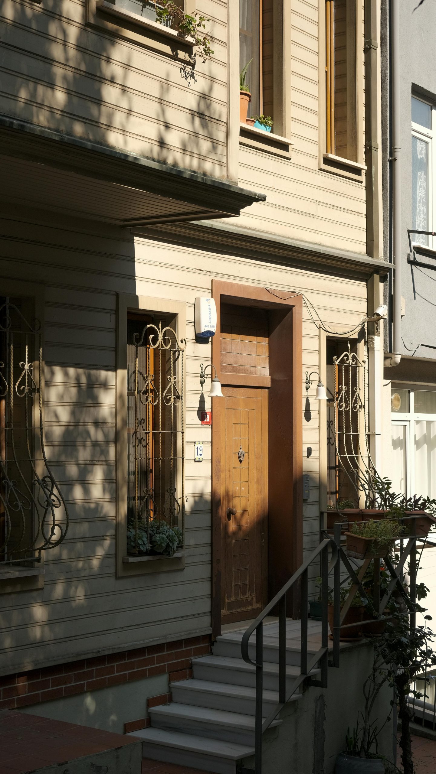 A beautifully lit wooden house entrance with ornate windows in Üsküdar, Istanbul, Türkiye.