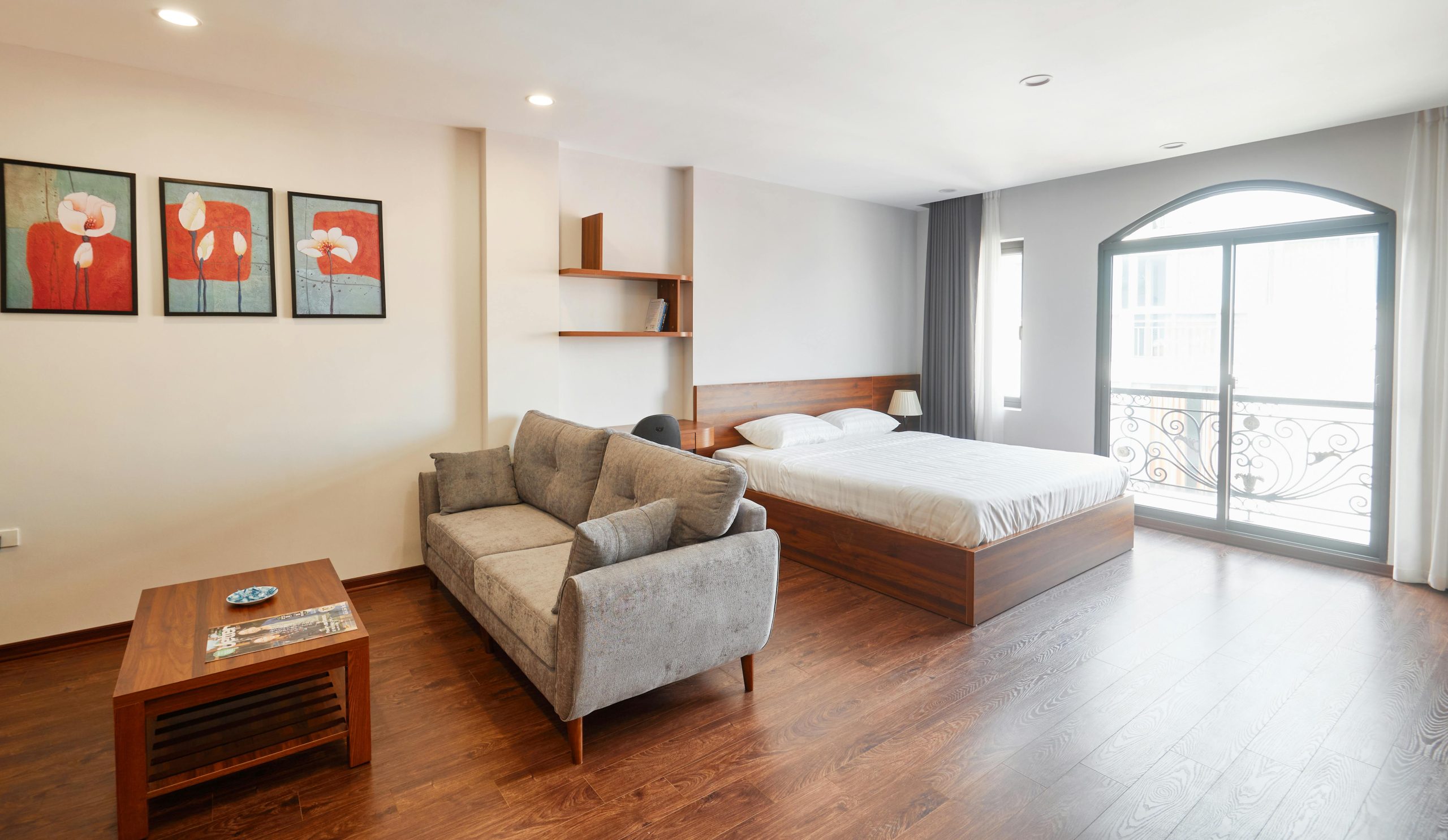 A bright and airy bedroom featuring elegant furniture and stylish decor with natural lighting.