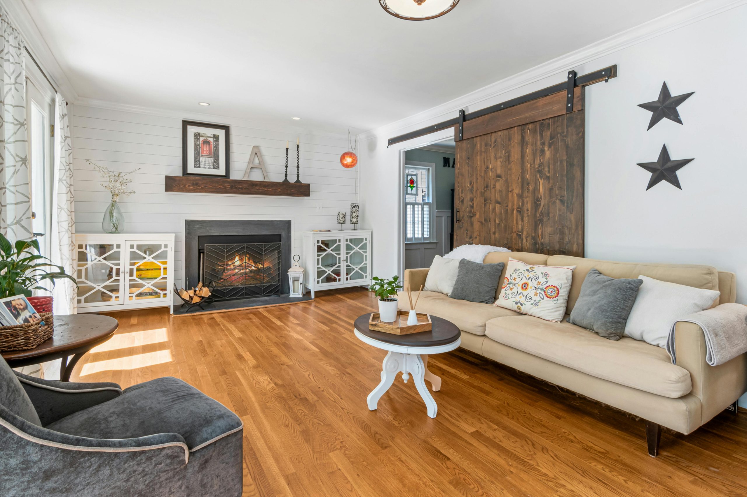 A bright and cozy modern farmhouse living room with fireplace and elegant decor.