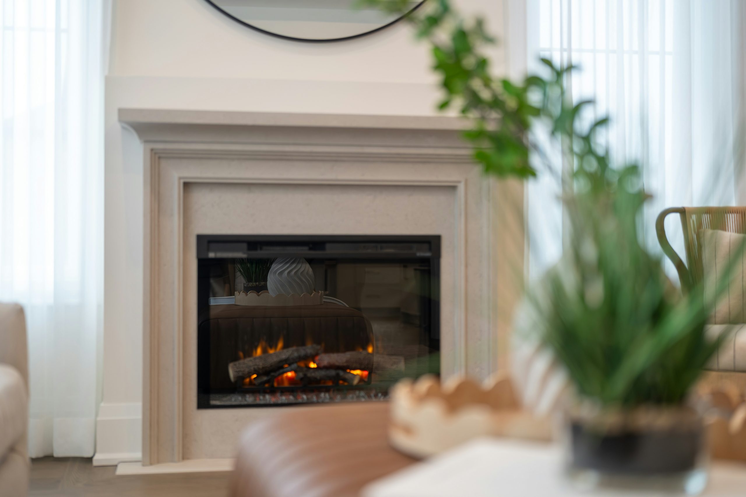 A modern fireplace with a warm glowing fire.