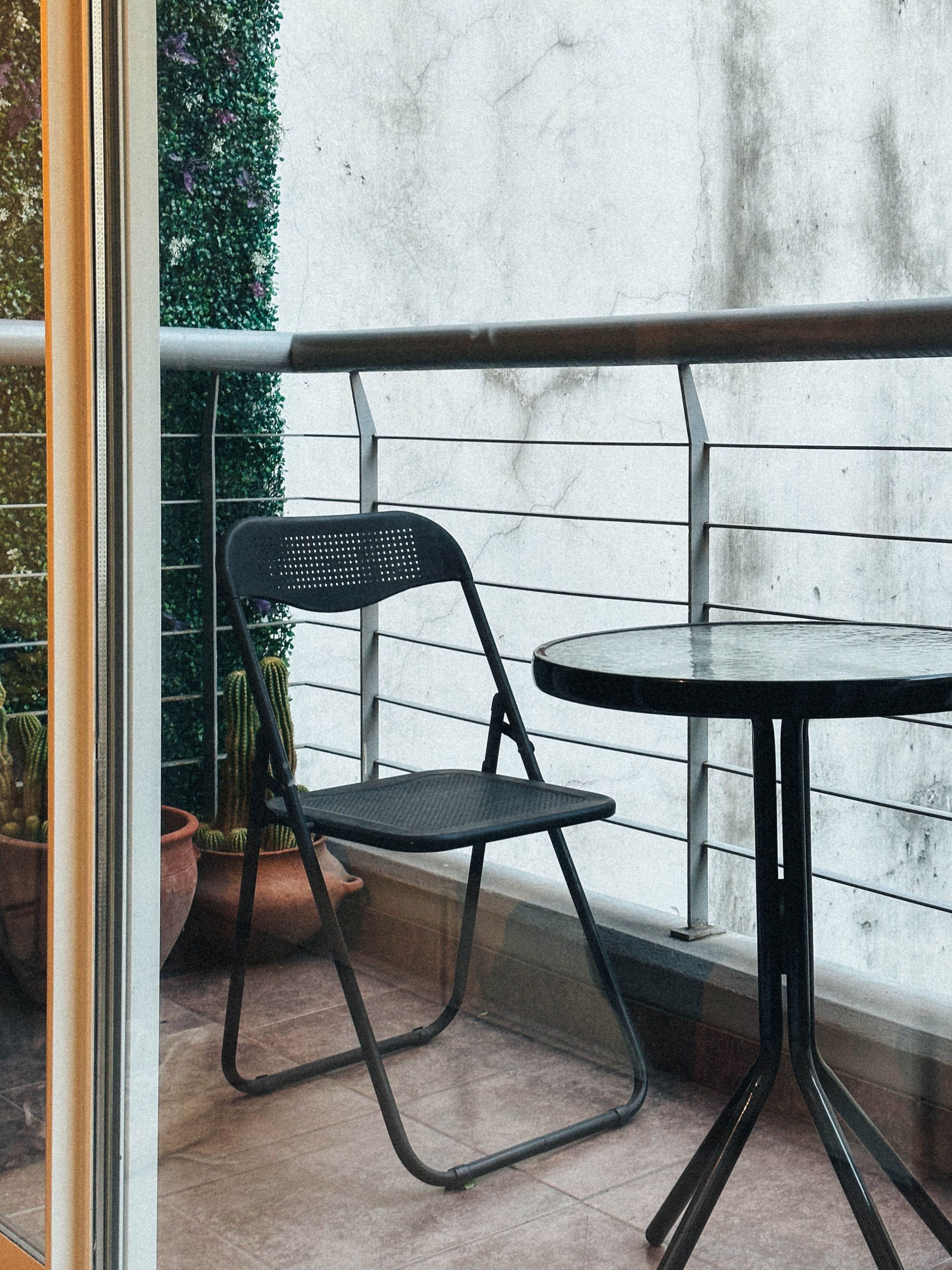 A simple, peaceful balcony with a chair and table in Buenos Aires.