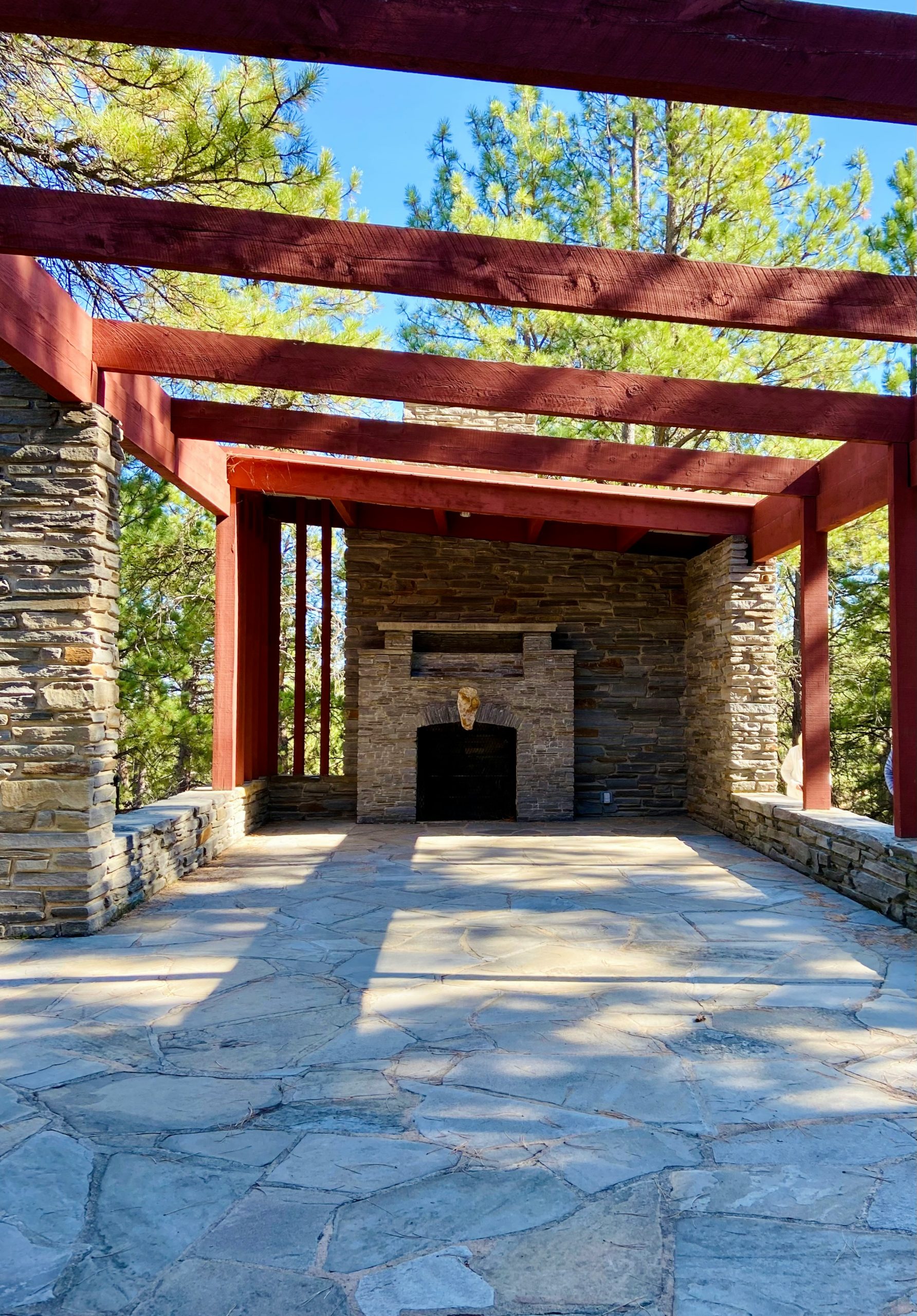 a stone patio with a fire place in the middle of it