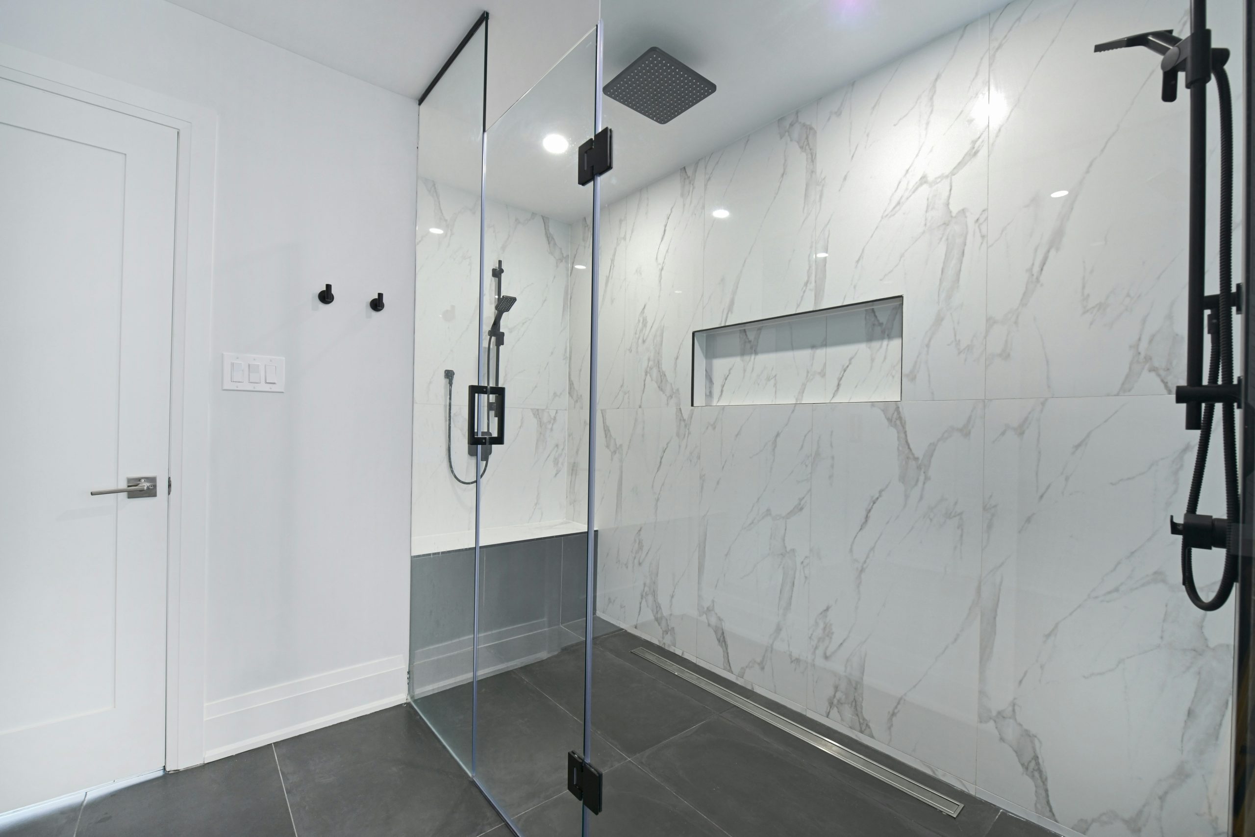 A walk-in shower is a modern, open-style shower area with little to no step or curb, designed for easy access and a spacious feel. Typically framed with frameless or semi‑frameless glass, it blends se