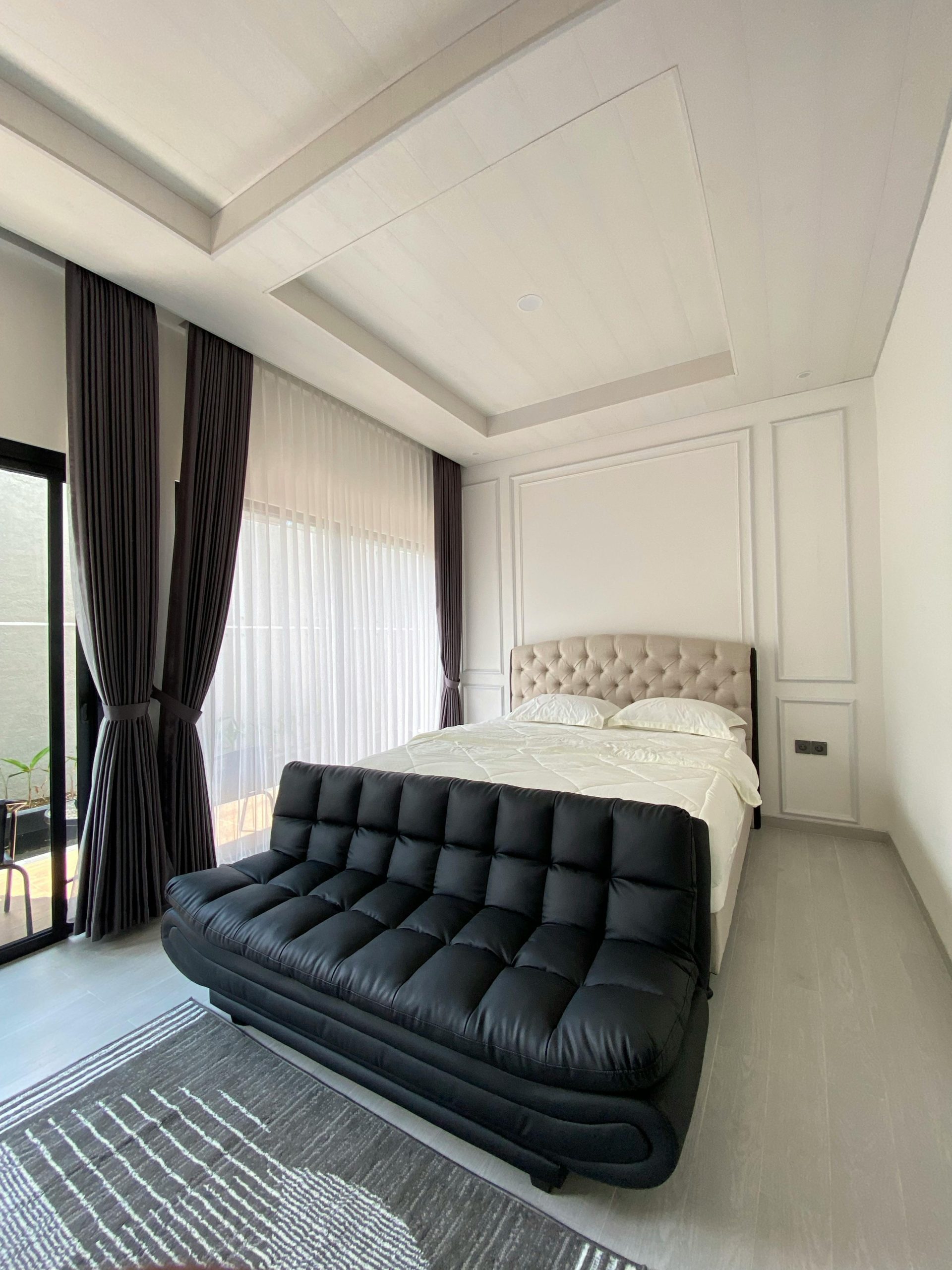 Bright and elegant modern bedroom with natural light and minimalist decor.