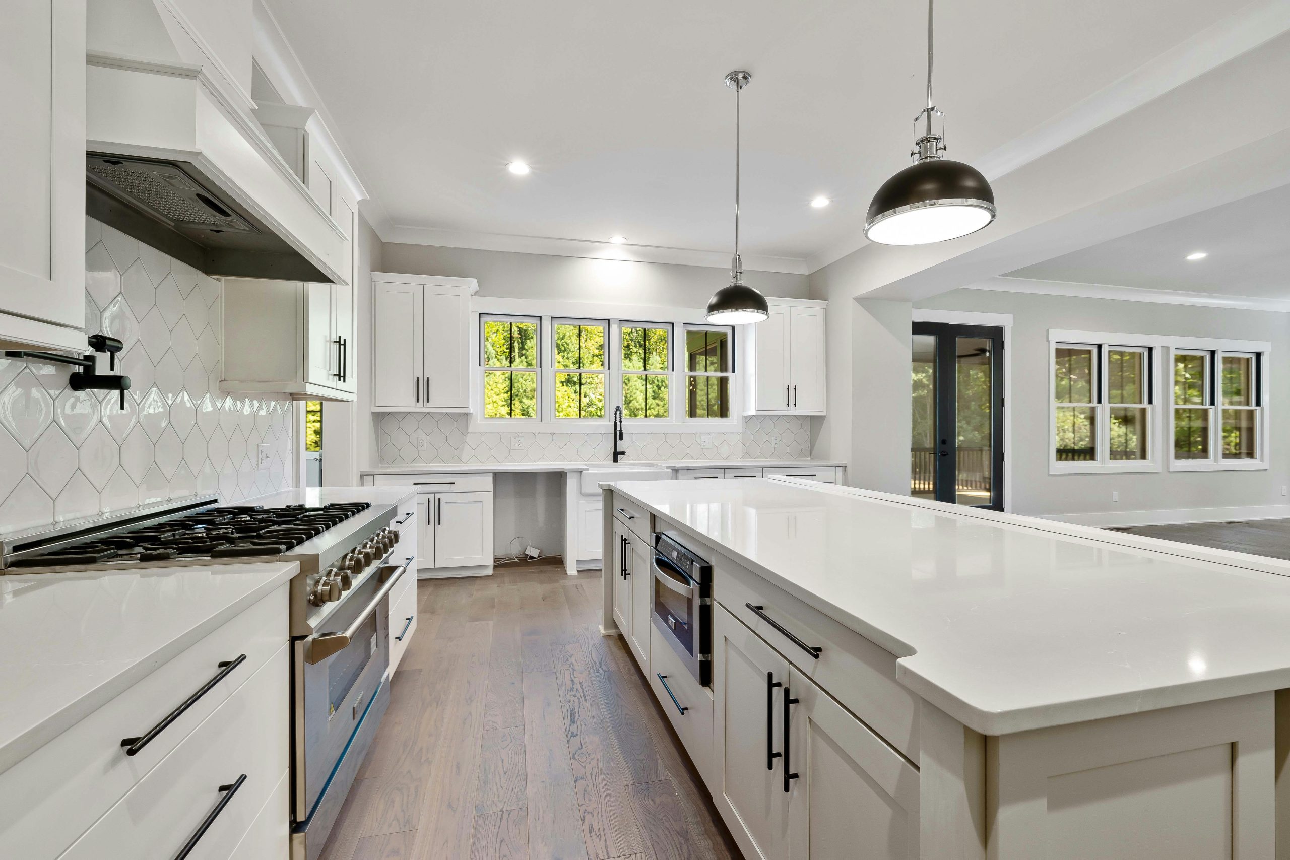 Bright modern kitchen with white cabinets and large island countertop.