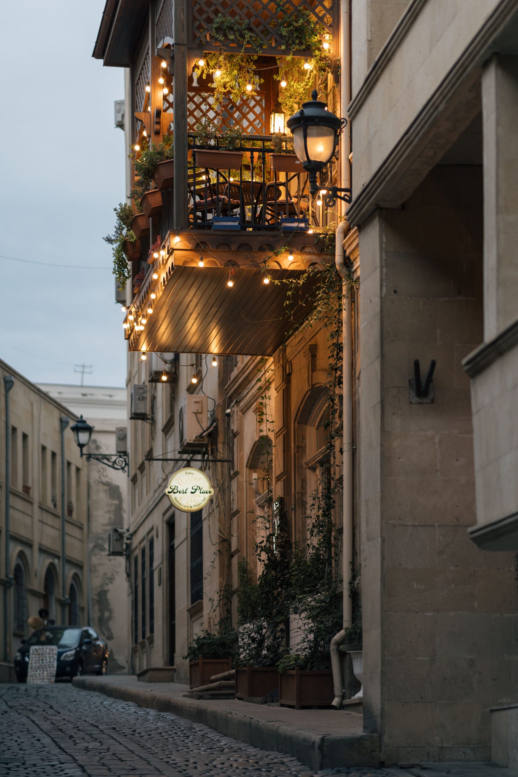 Charming illuminated balcony in the historic streets of Baku's Old Town, showcasing vibrant urban ambiance.