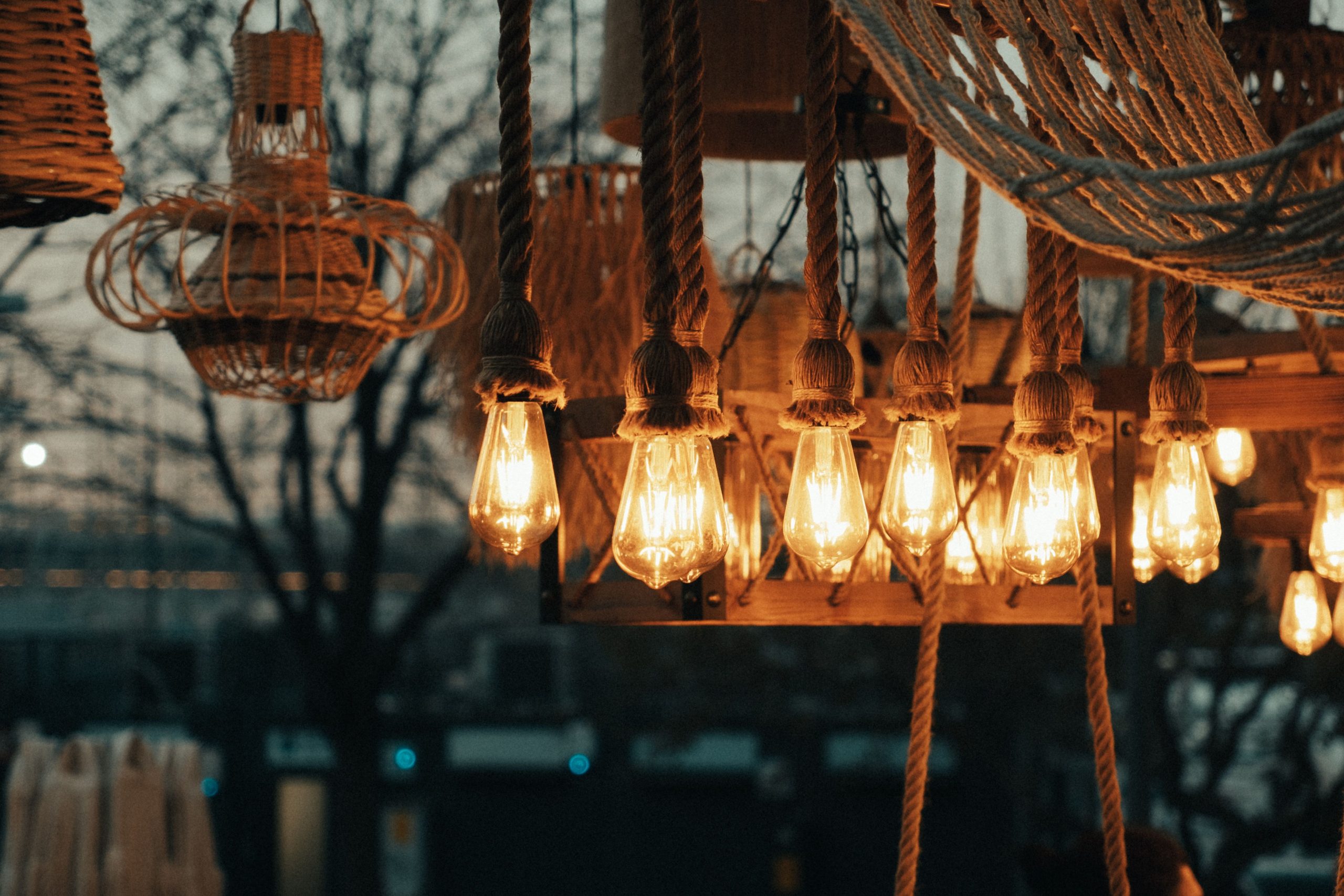 Close-up of glowing lanterns outdoors during twilight, enhancing a warm ambiance.