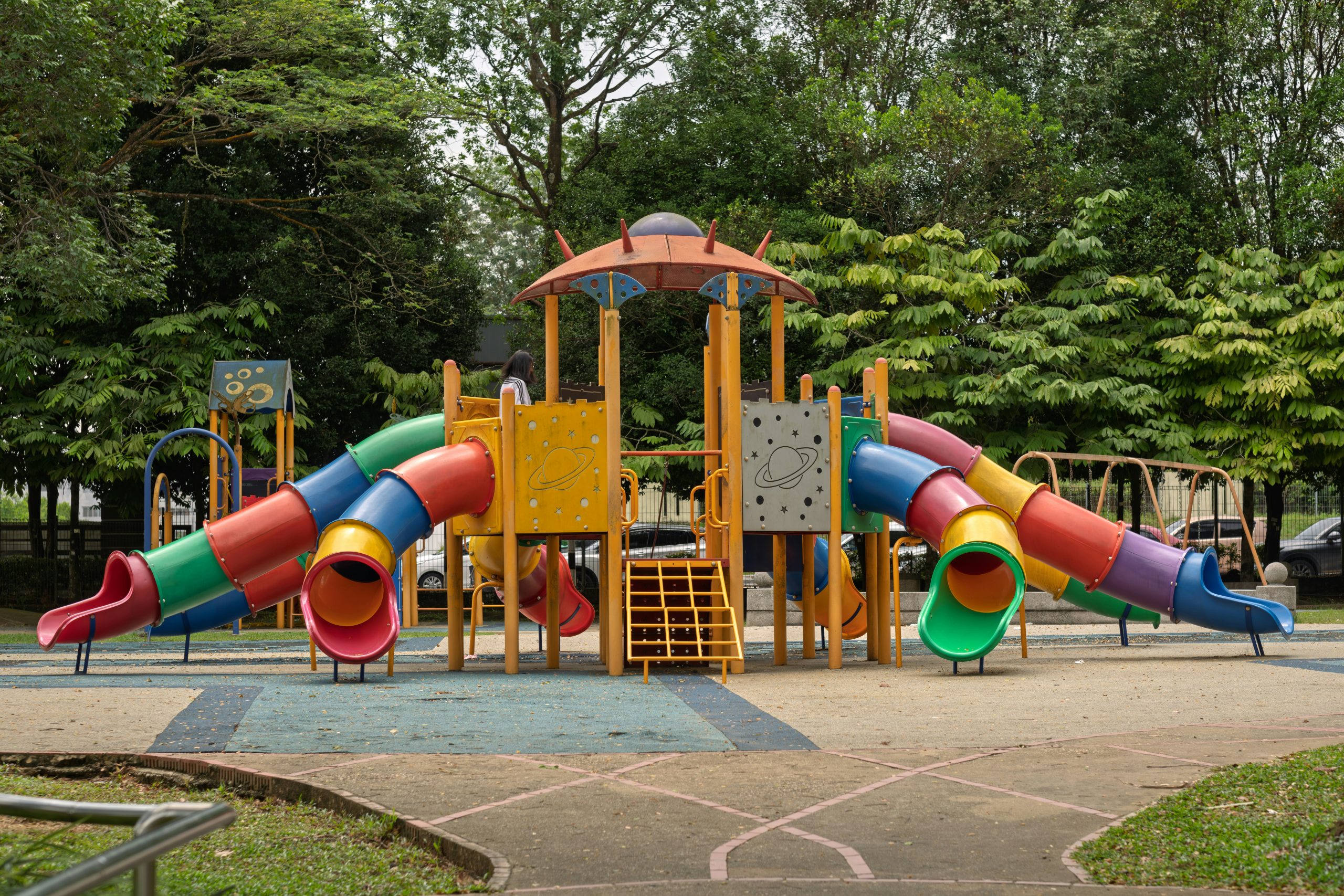 Colorful playground with slides and climbing structures.