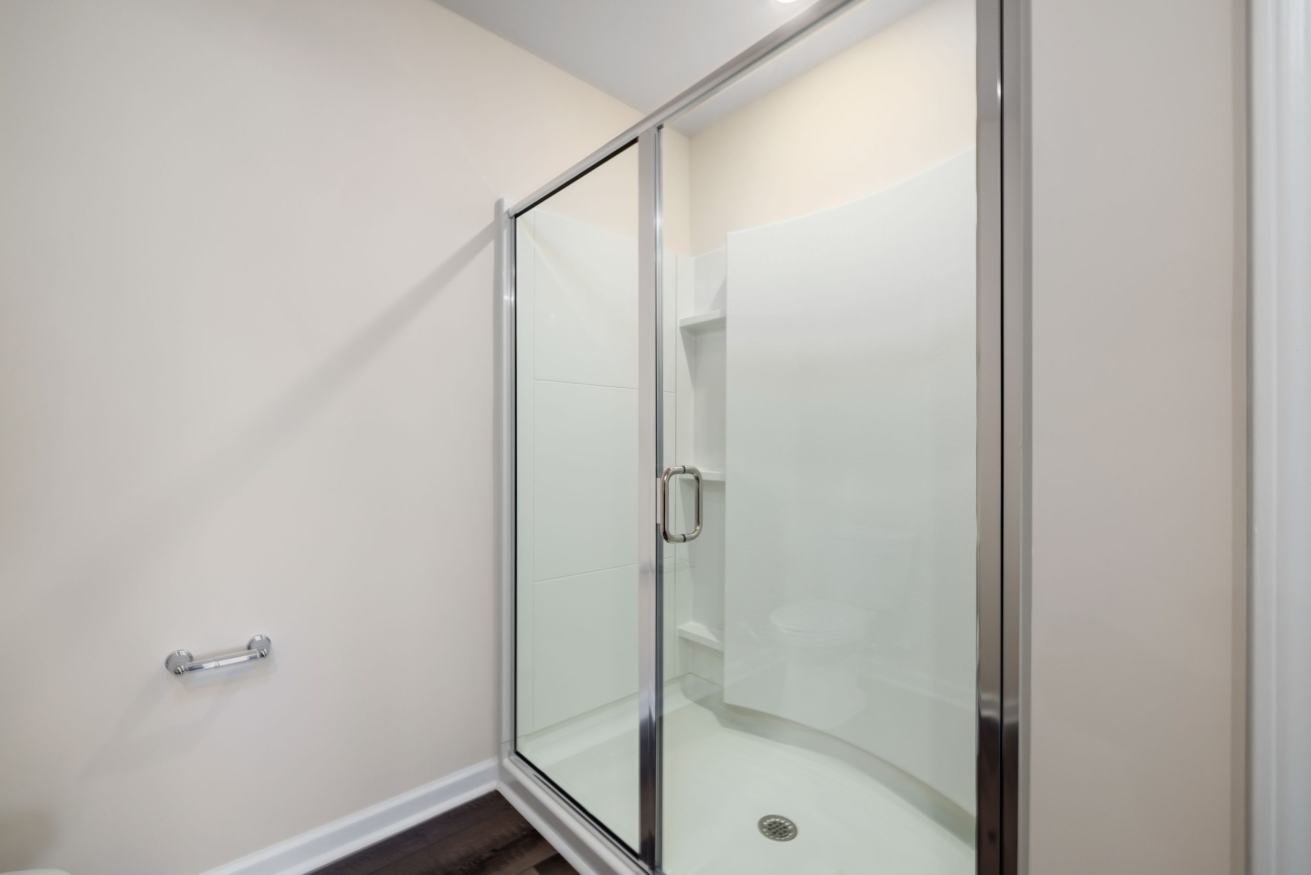 Contemporary glass shower with minimalist design, showing clean and spacious interior.