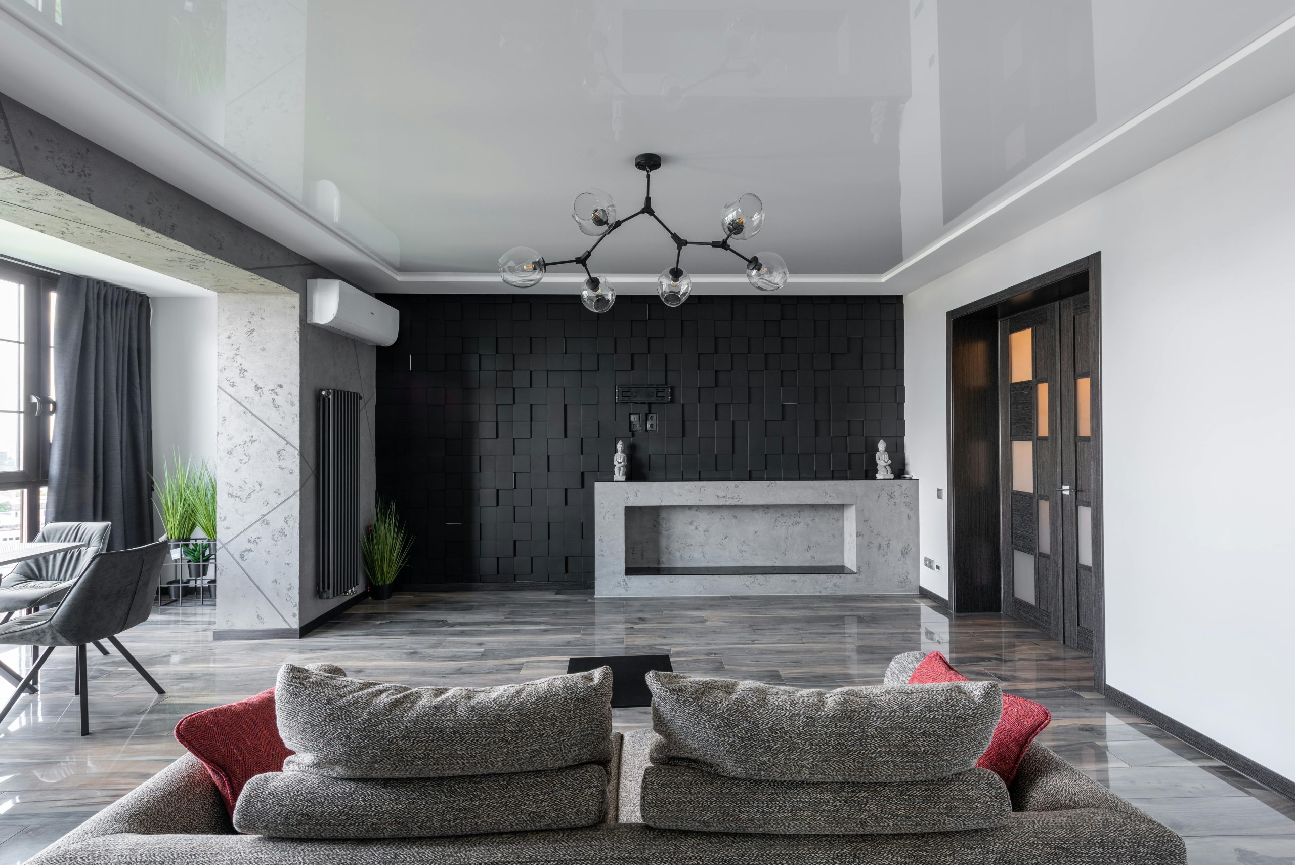 Contemporary living room with a modern black accent wall, chic furniture, and stylish lighting.