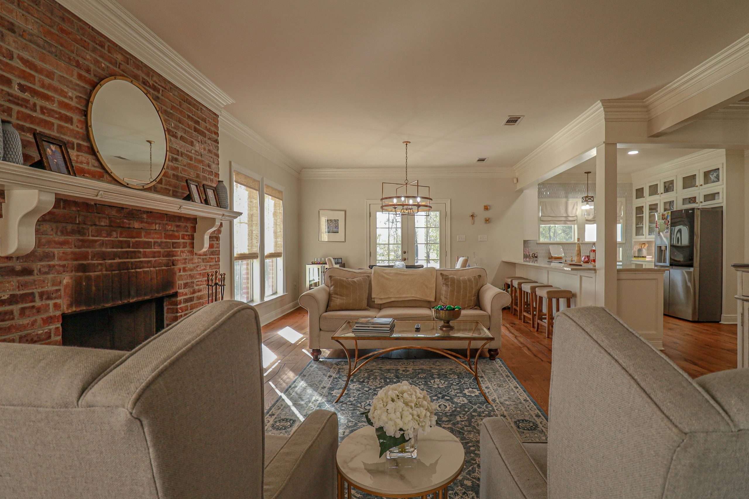 Cozy living room with brick fireplace and comfortable seating.