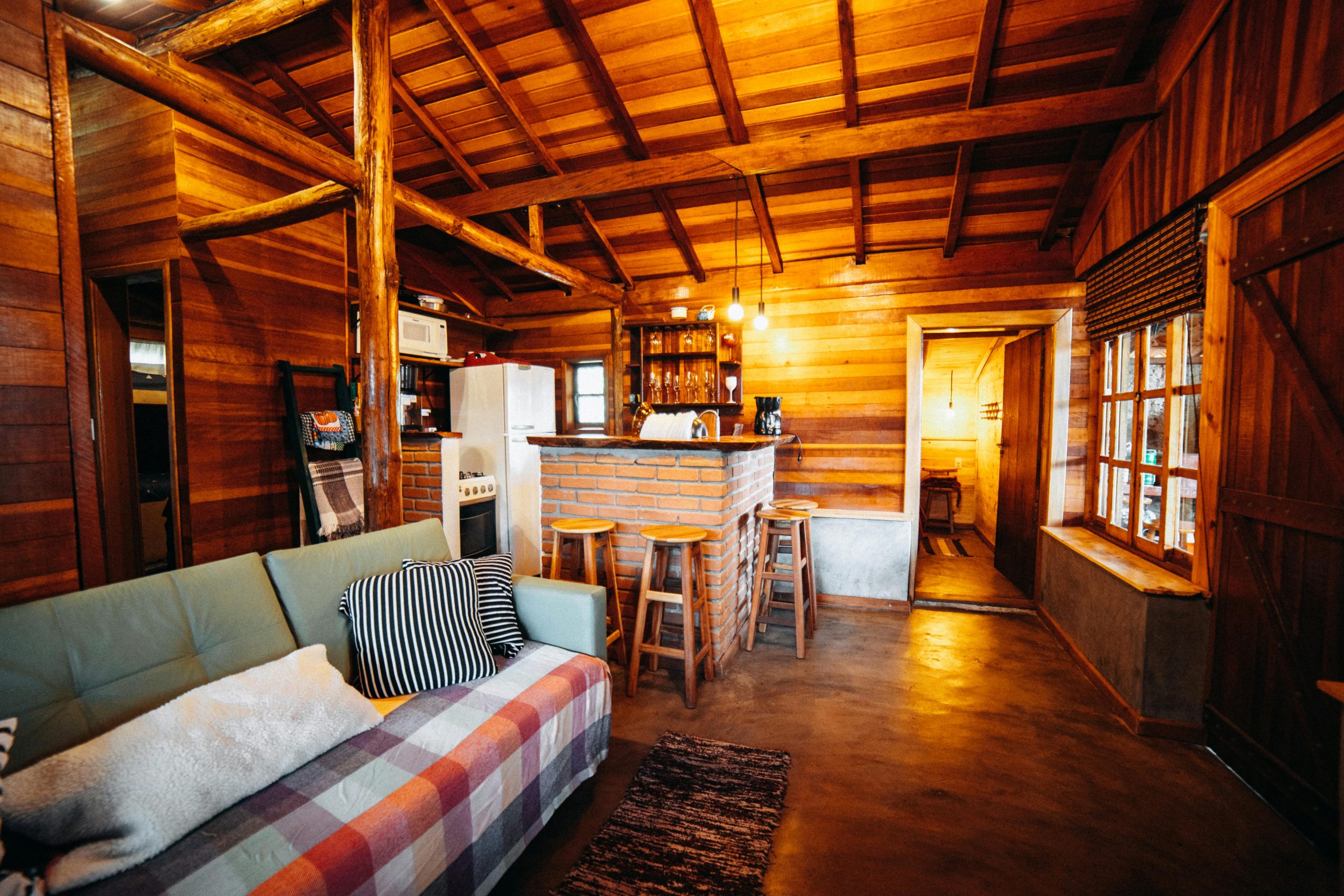 Cozy wooden cabin living space with warm lighting and rustic design elements.