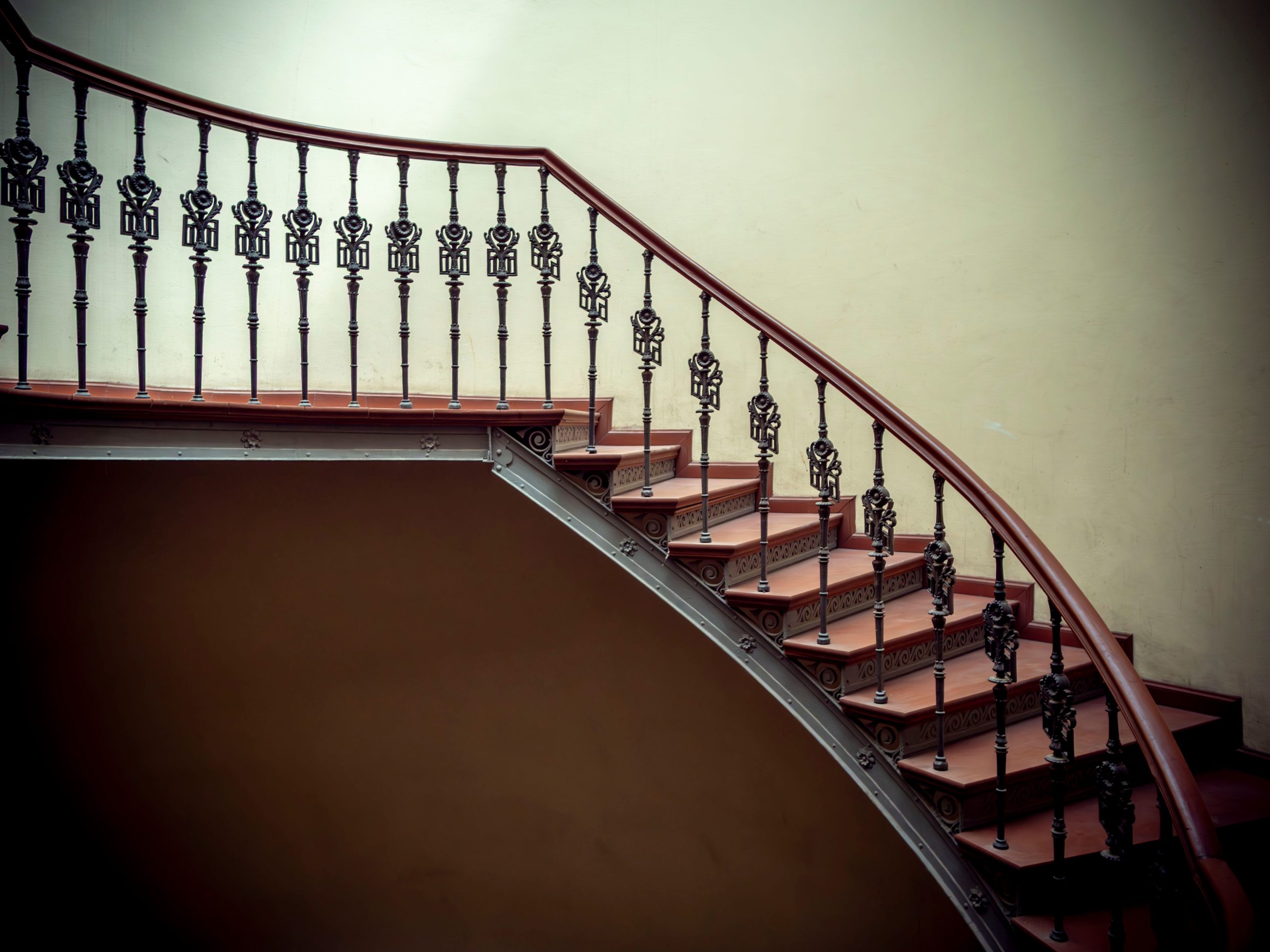 Curved wrought iron staircase with an ornate design in Wrocław, Poland.