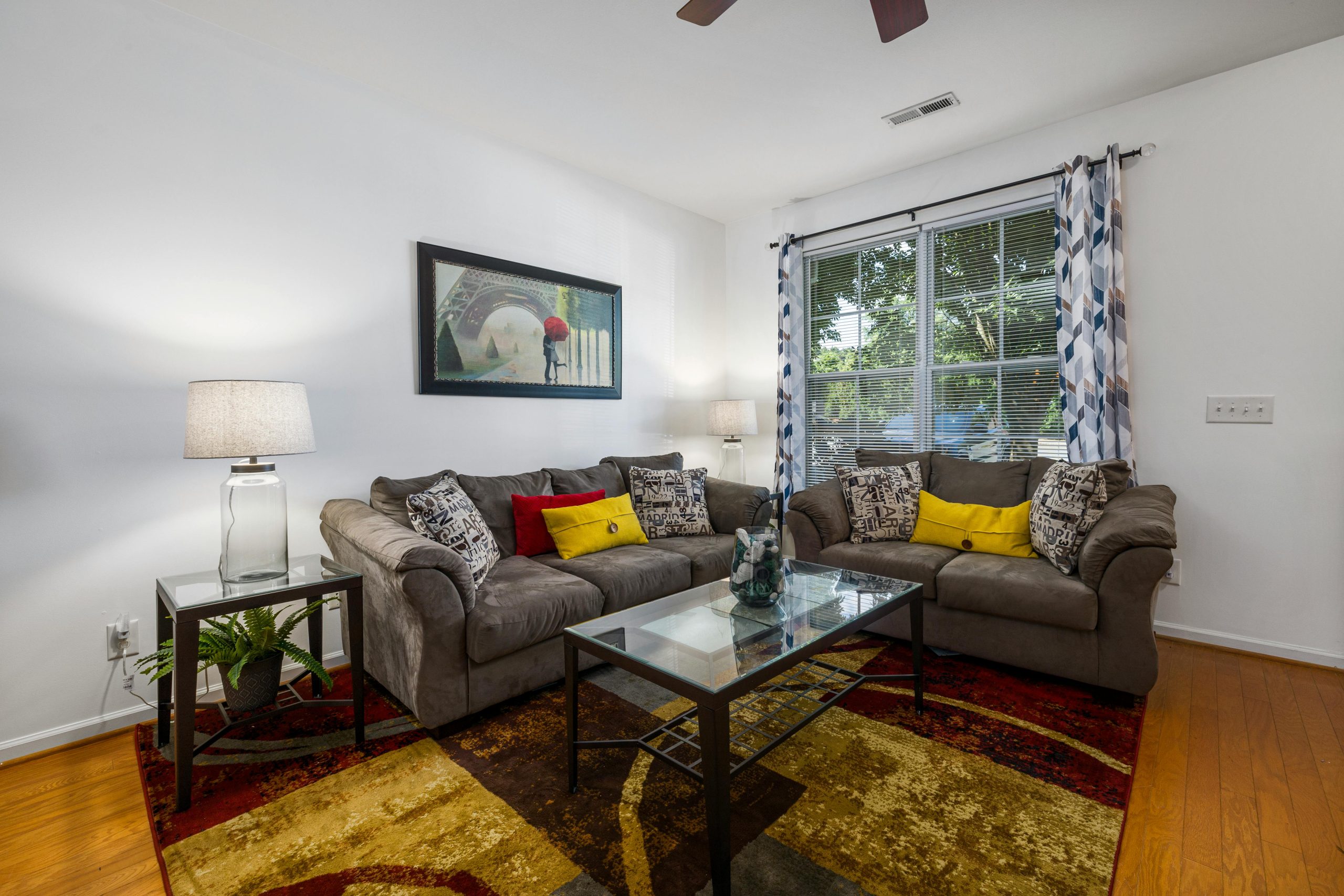 Elegant living room interior featuring a glass coffee table, comfortable sofas, and stylish decor for a cozy ambiance.