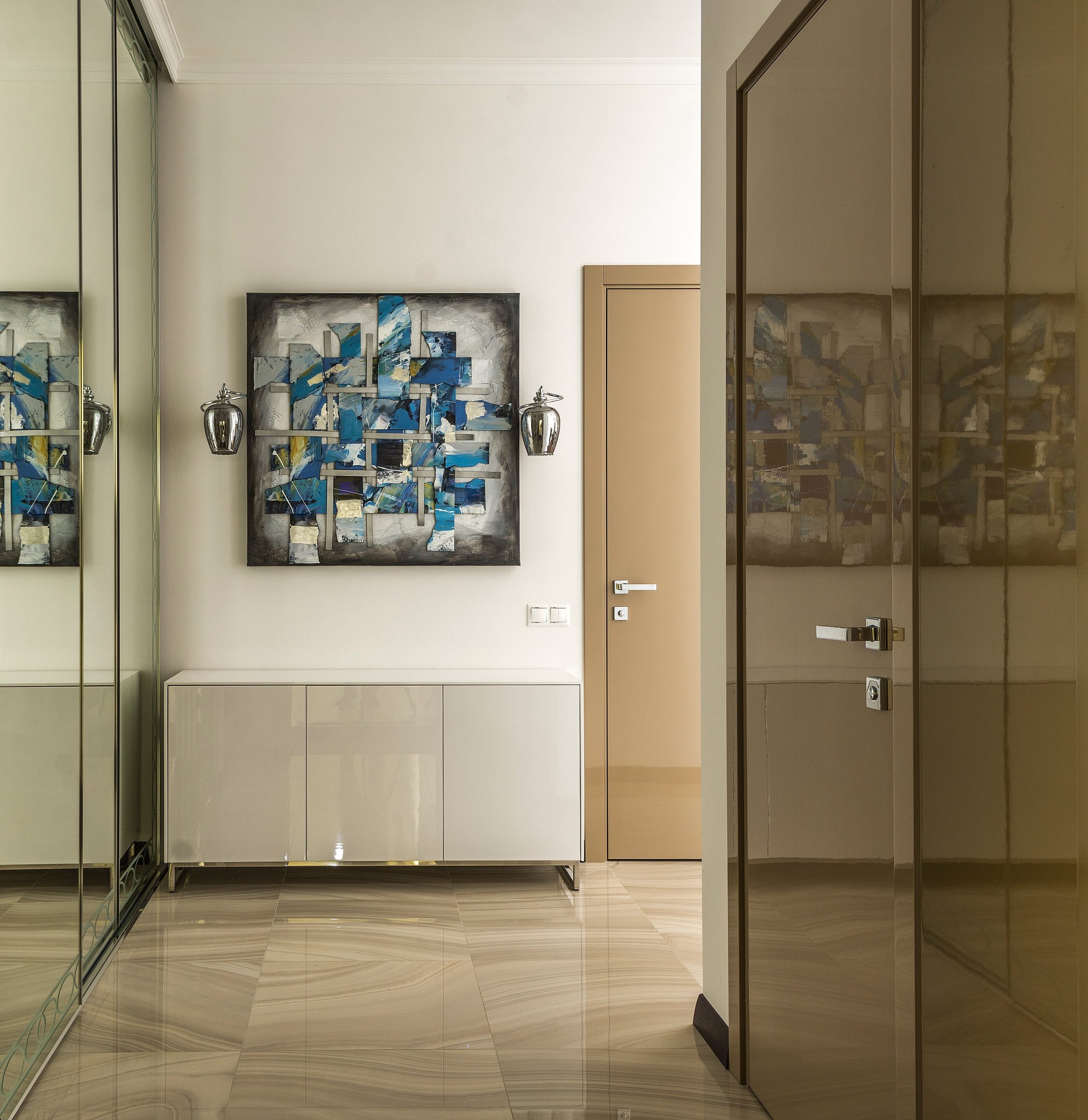 Empty spacious corridor with big wardrobe with mirror doors and abstract picture on wall