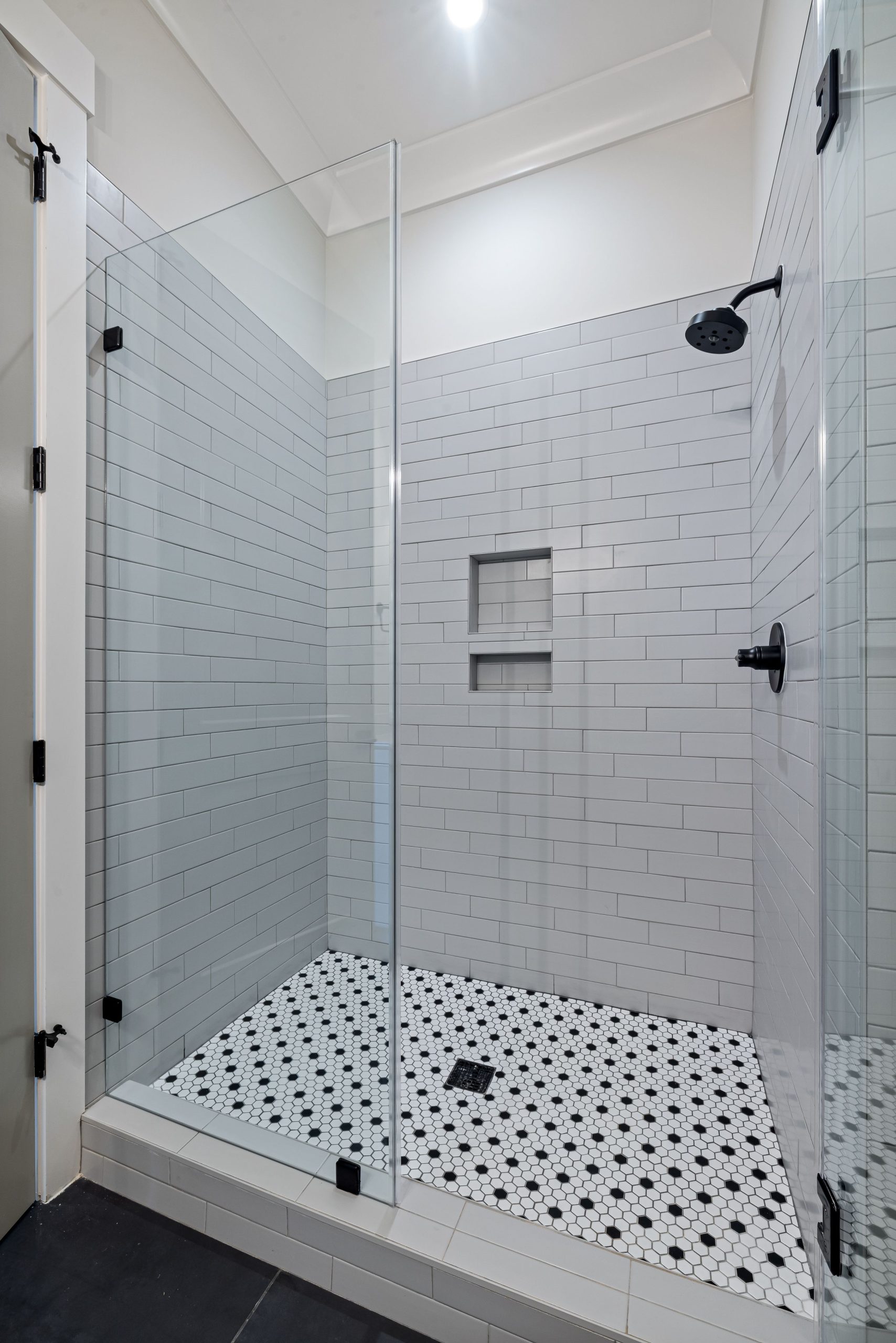 Explore a sleek modern shower in a luxury minimalist bathroom with high-end features.