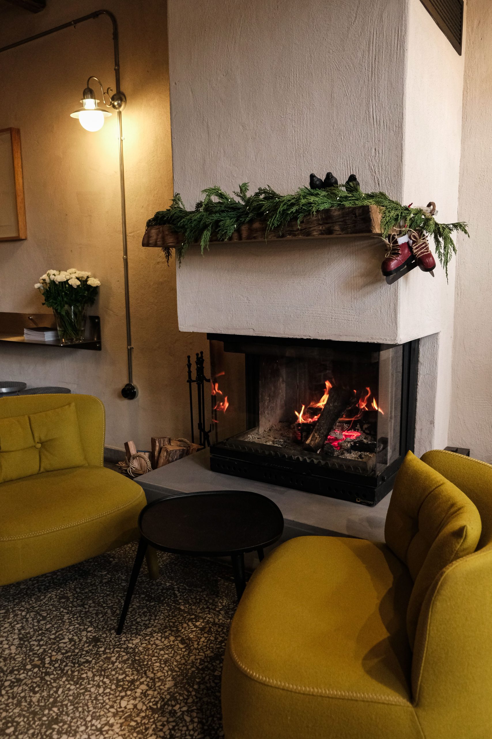 Inviting living room interior with warm fireplace and stylish yellow chairs.