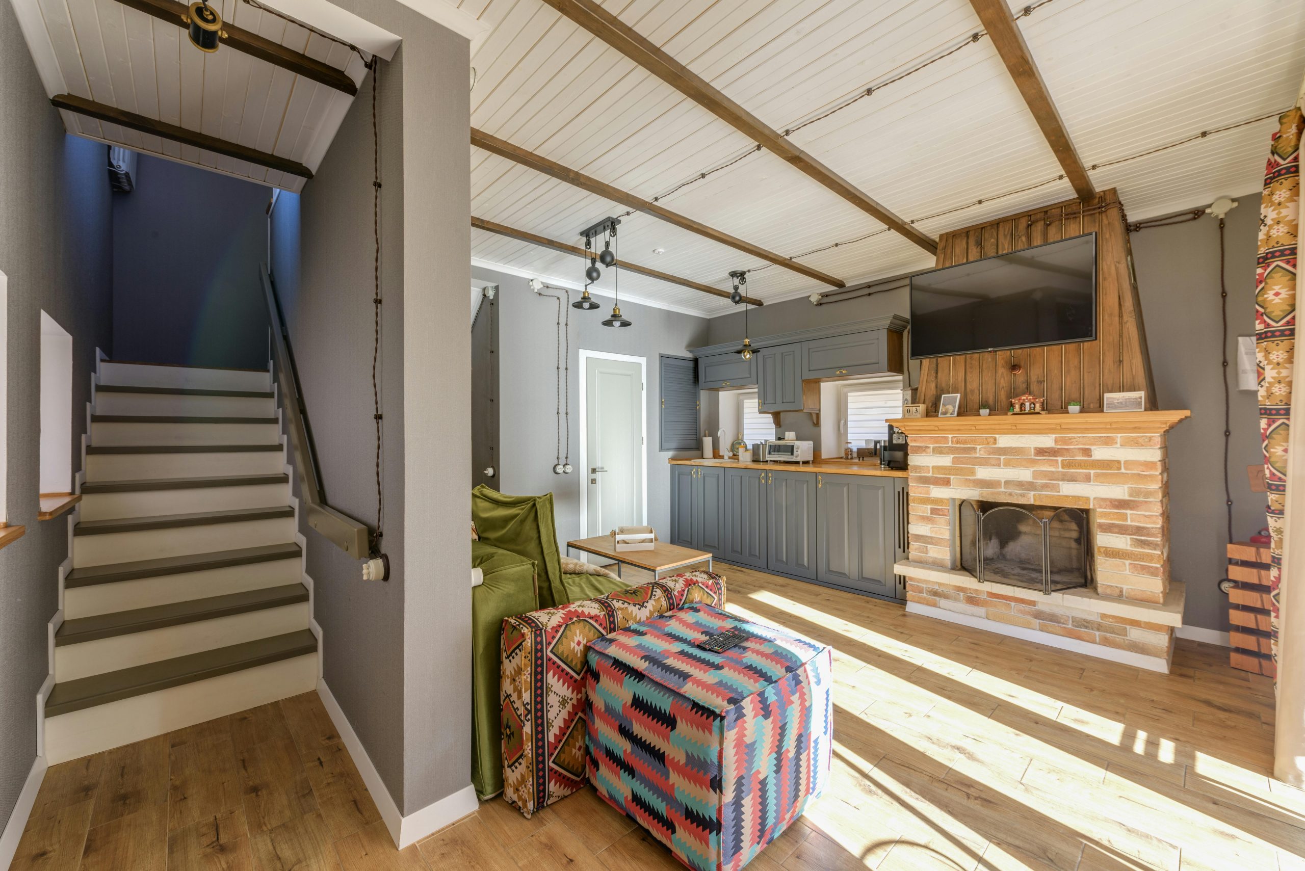 Inviting living room with rustic fireplace and colorful decor.