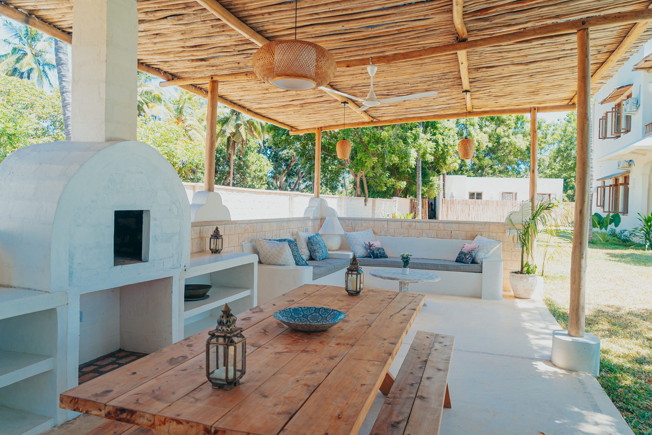 Inviting outdoor patio with rustic furniture and natural decor, ideal for relaxation.