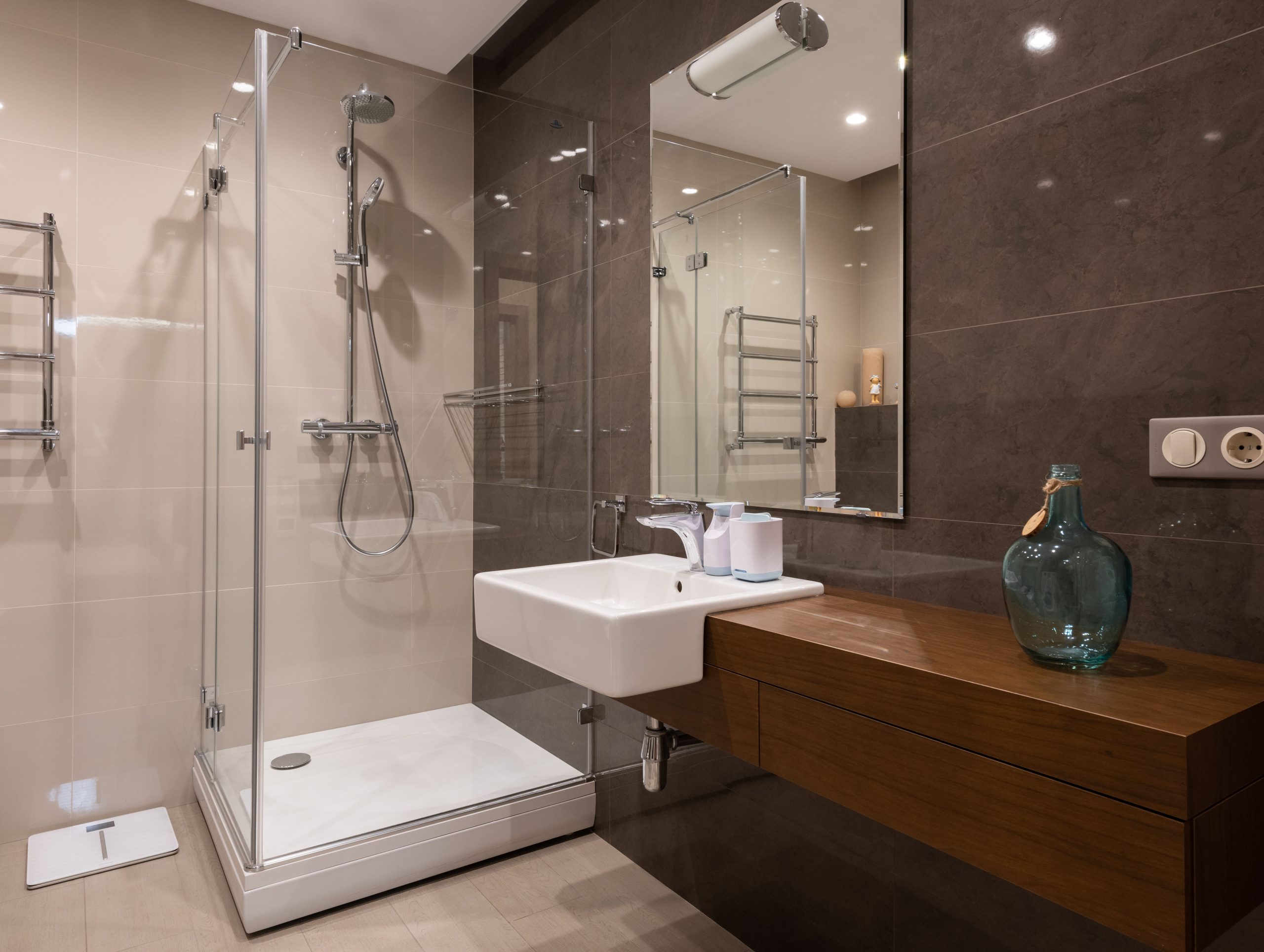 Luxurious contemporary bathroom featuring glass shower and sleek minimal design.