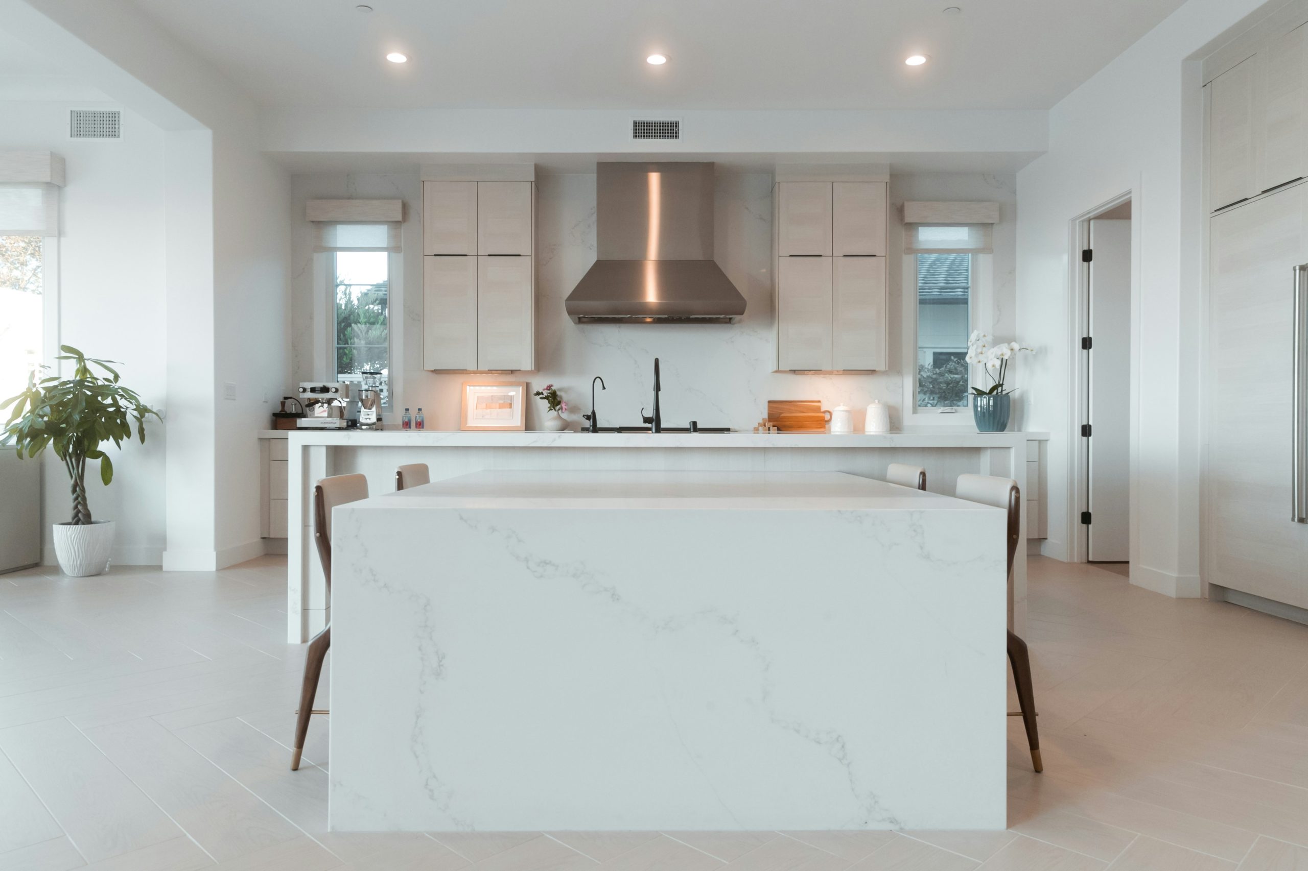 Luxurious kitchen with white walls and soft recessed lighting.