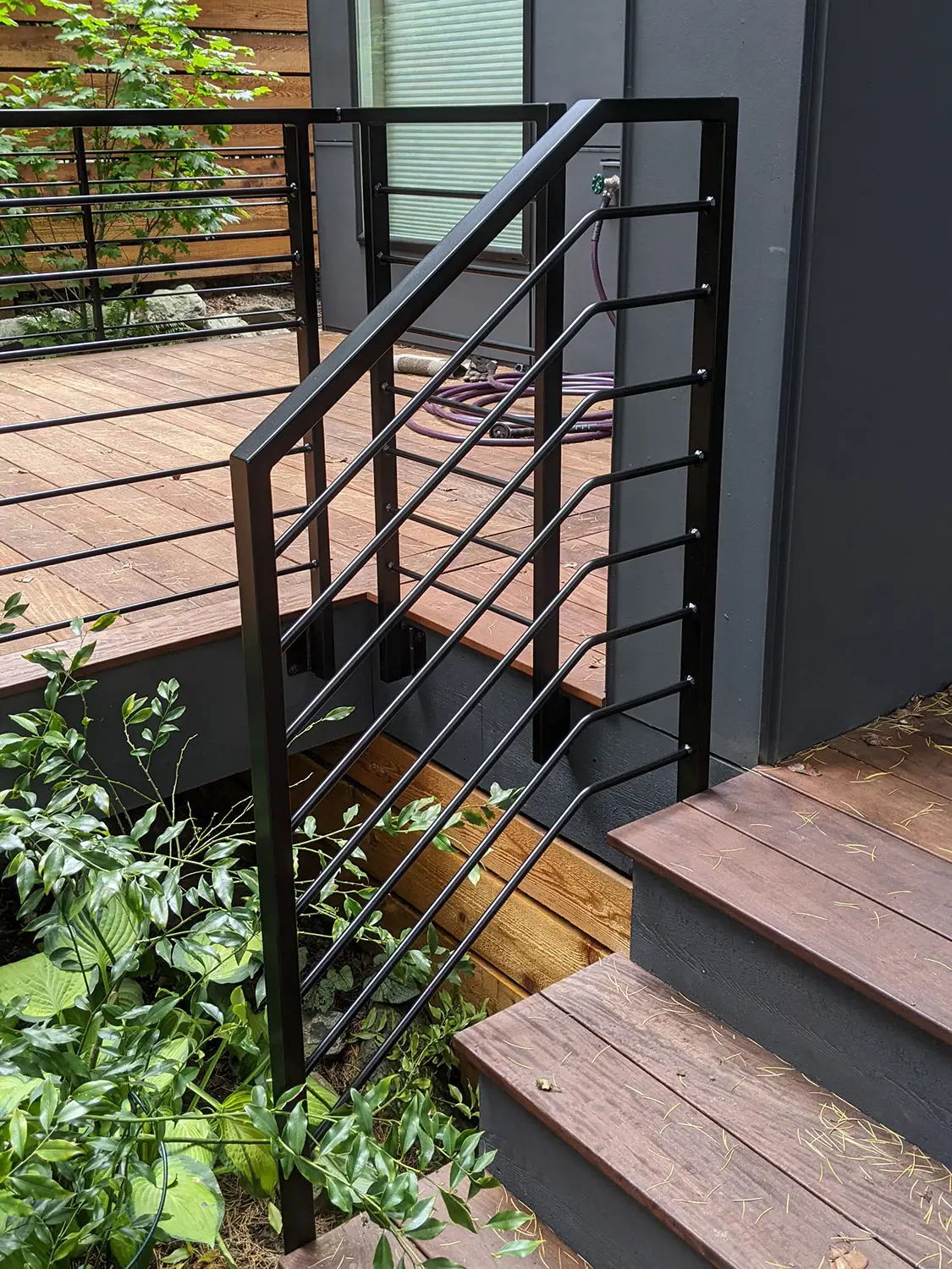 Modern horizontal deck railing with round bar infill - Blackbird Iron & Design
