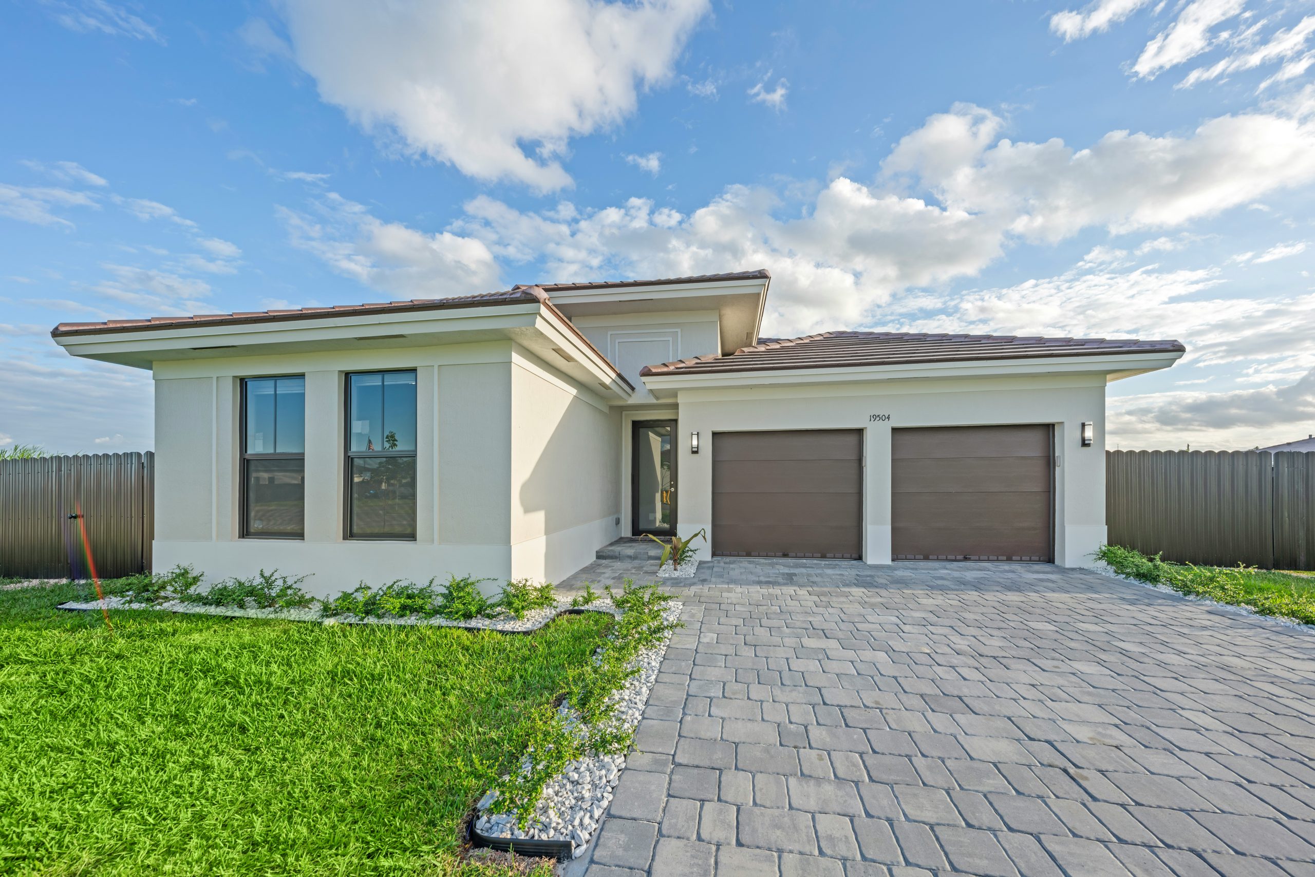 Modern house with a paved driveway and garage.