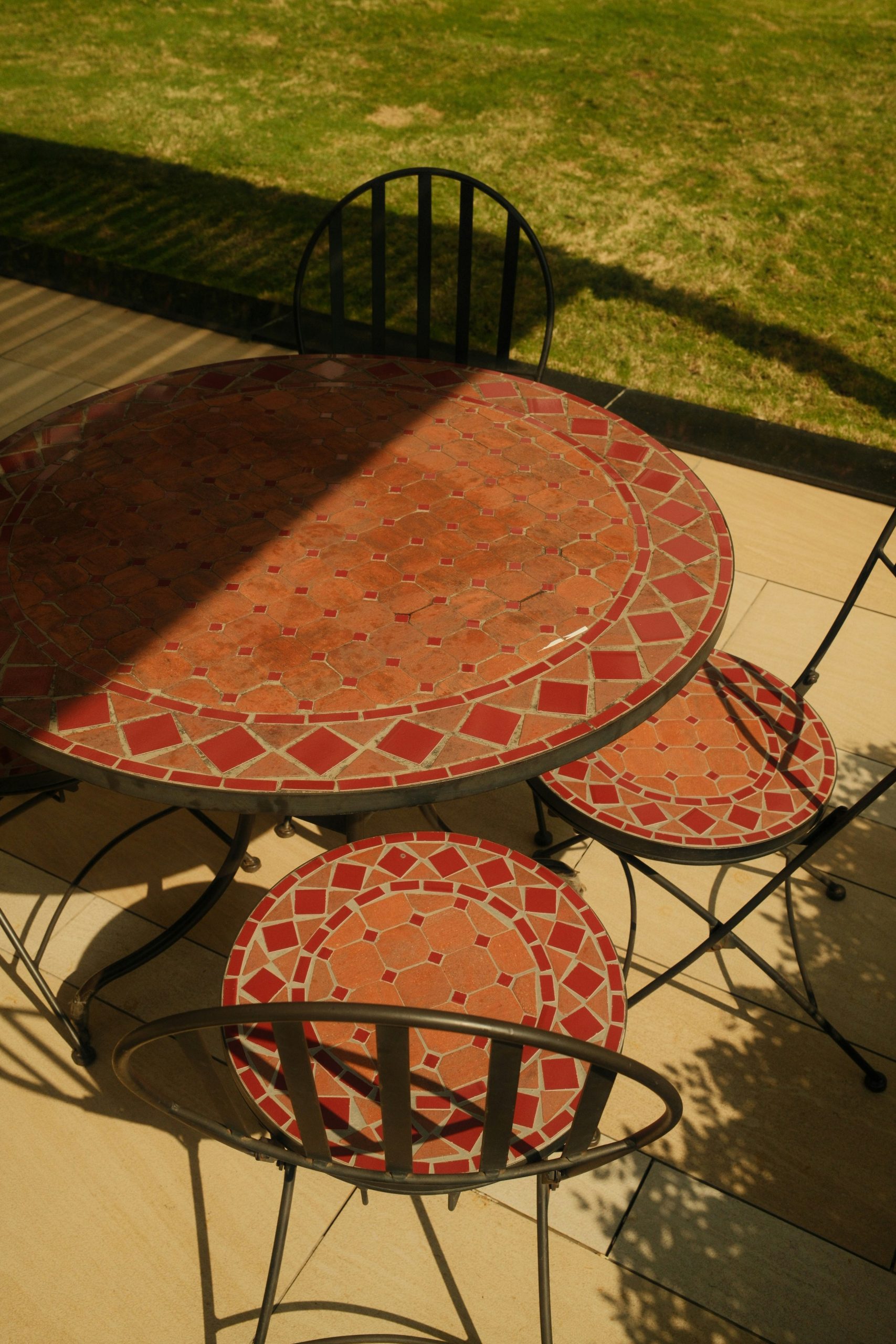 Mosaic table and chairs on a sunny patio