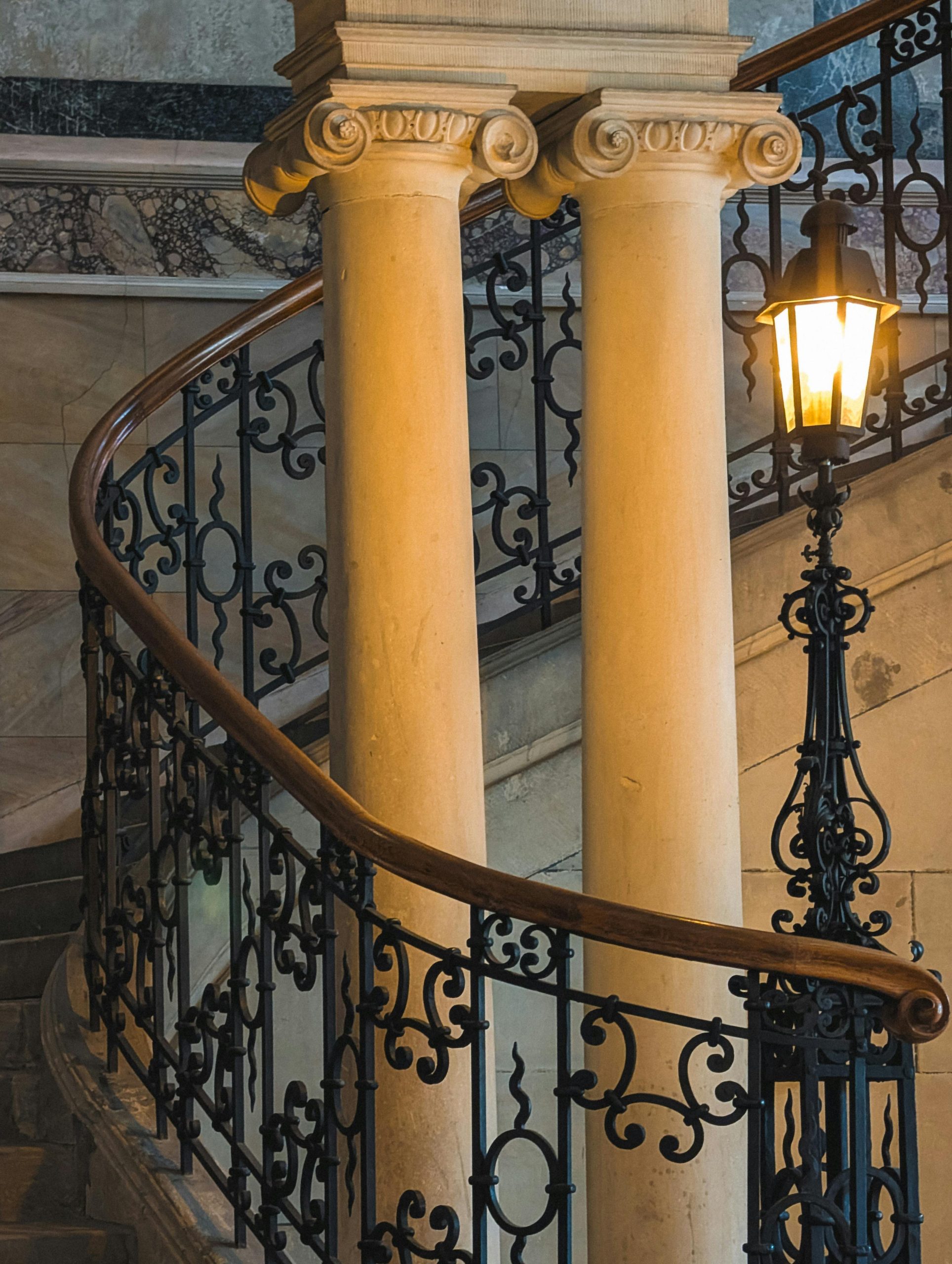 Ornate spiral staircase with wrought iron railings and classic columns, Bayreuth.