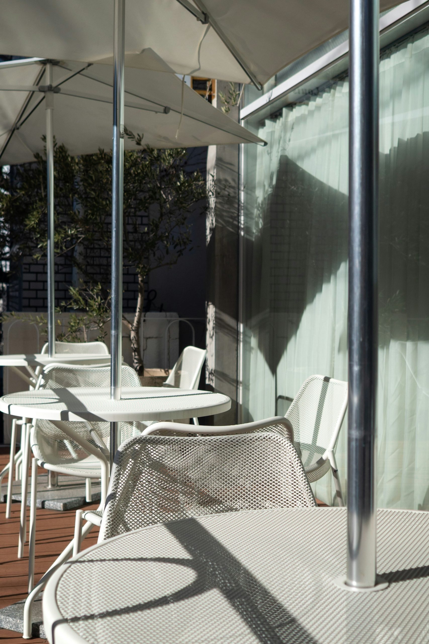 Outdoor cafe tables and chairs with umbrellas