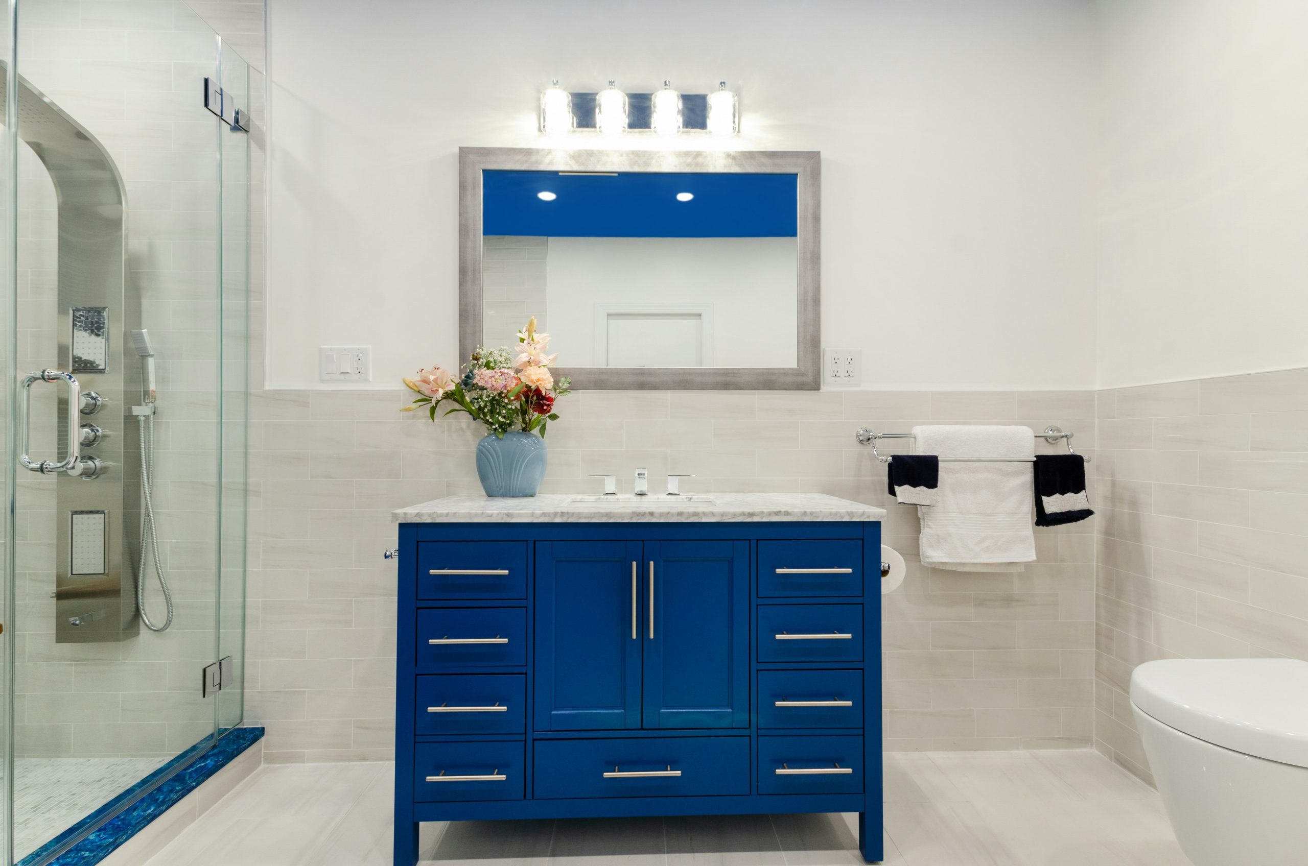 Renovated Brooklyn NY Bathroom. Blue bathroom. White Bathroom. Blue ceiling. Blue vanity. Blue tile. Jacuzzi tub. white tiles. stand up shower. 