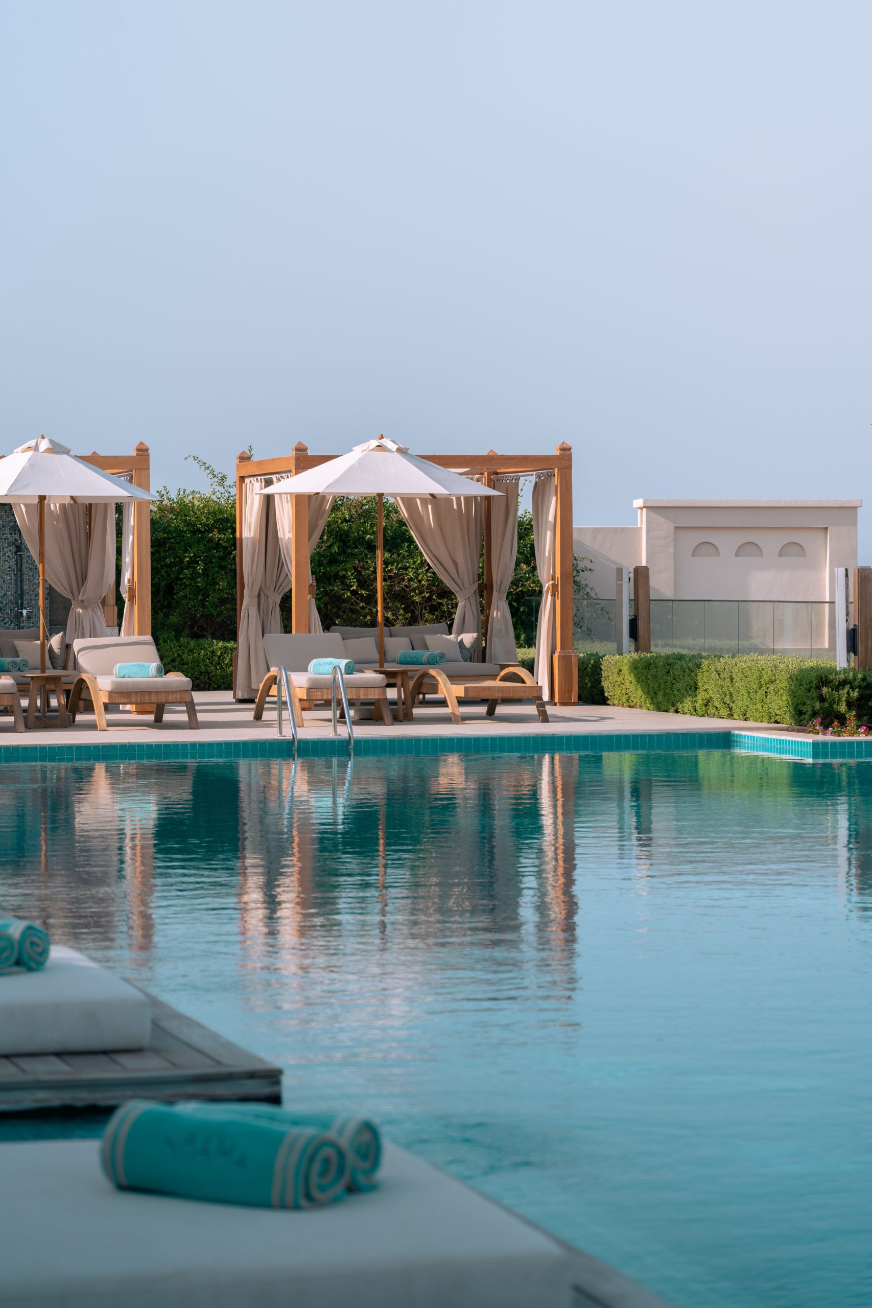 Serene poolside view with cabanas in a Dubai luxury resort, perfect for relaxation.