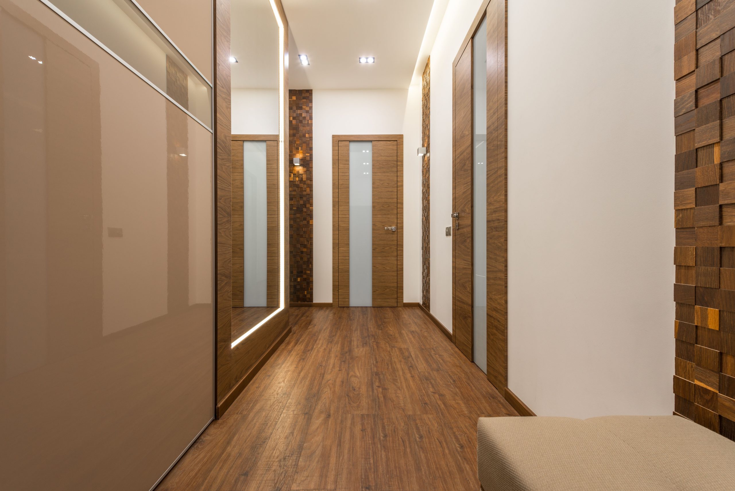 Sleek and luxurious hallway featuring wooden elements, elegant lighting, and modern design.