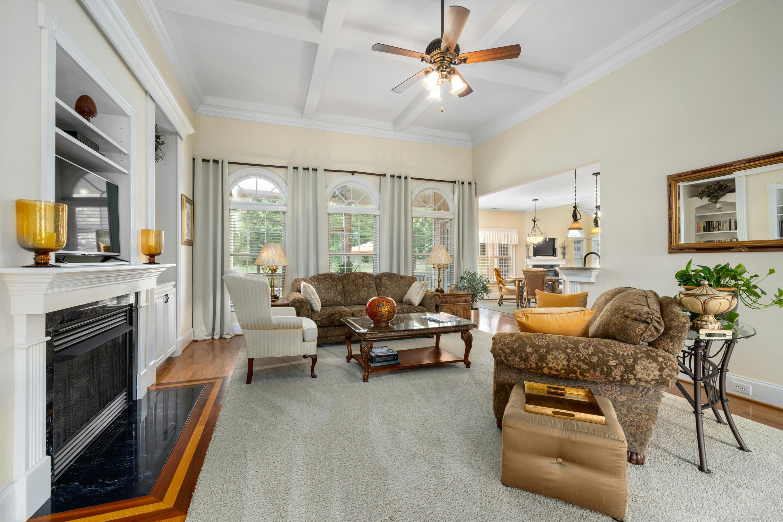 Spacious and elegantly designed living room featuring a cozy fireplace and stylish furniture.