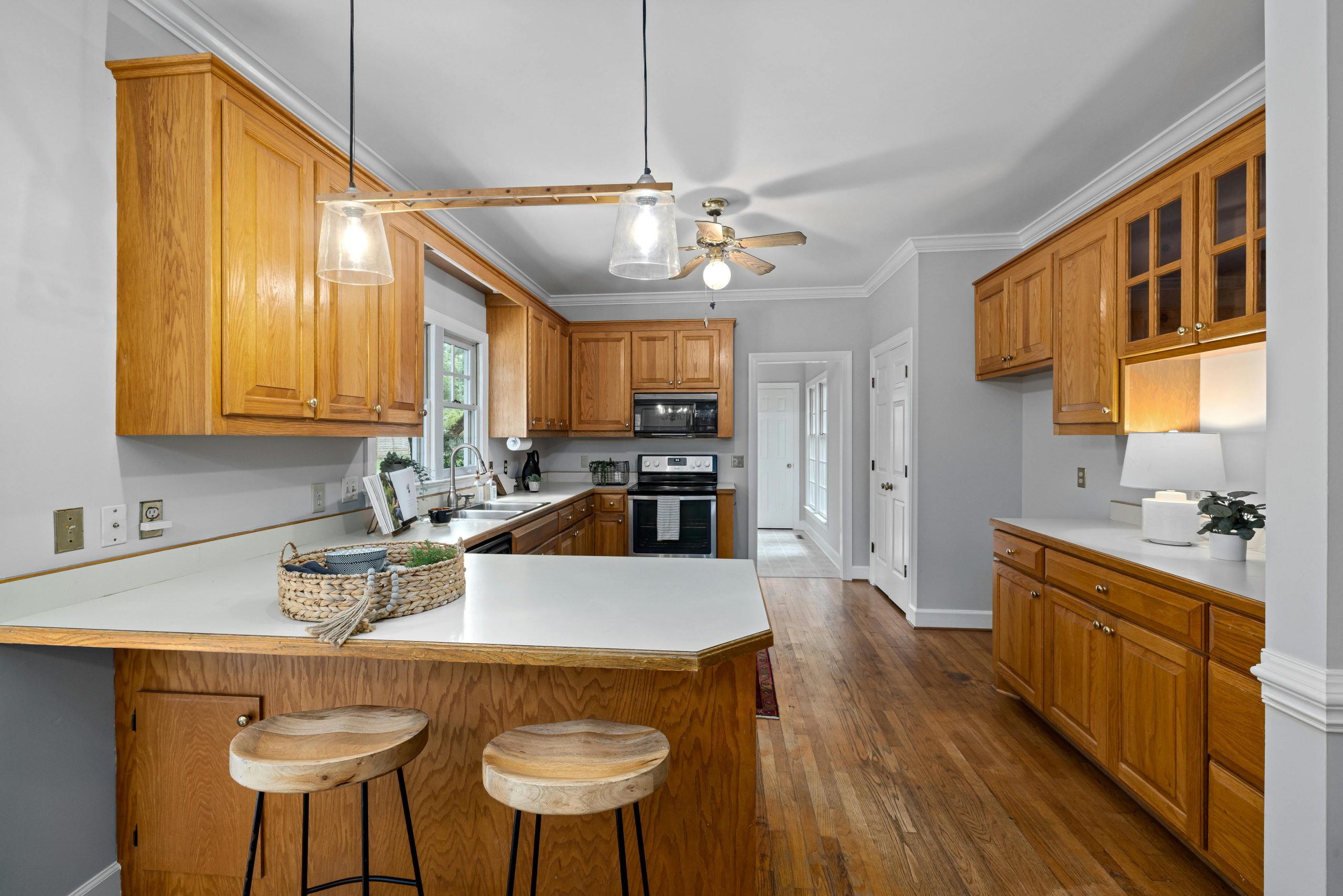 Spacious kitchen with wooden cabinets, island seating, and modern appliances.