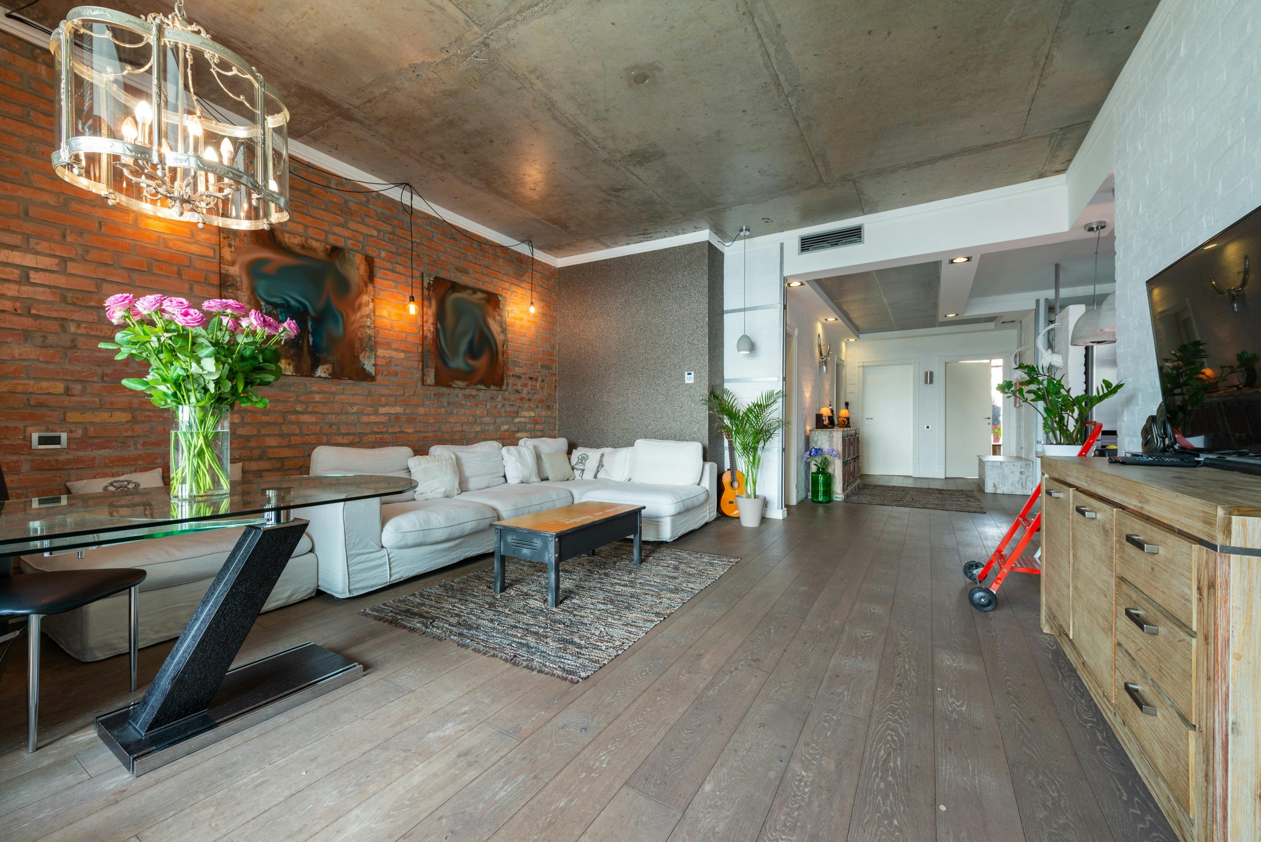 Spacious modern loft living room with elegant décor and industrial design elements.