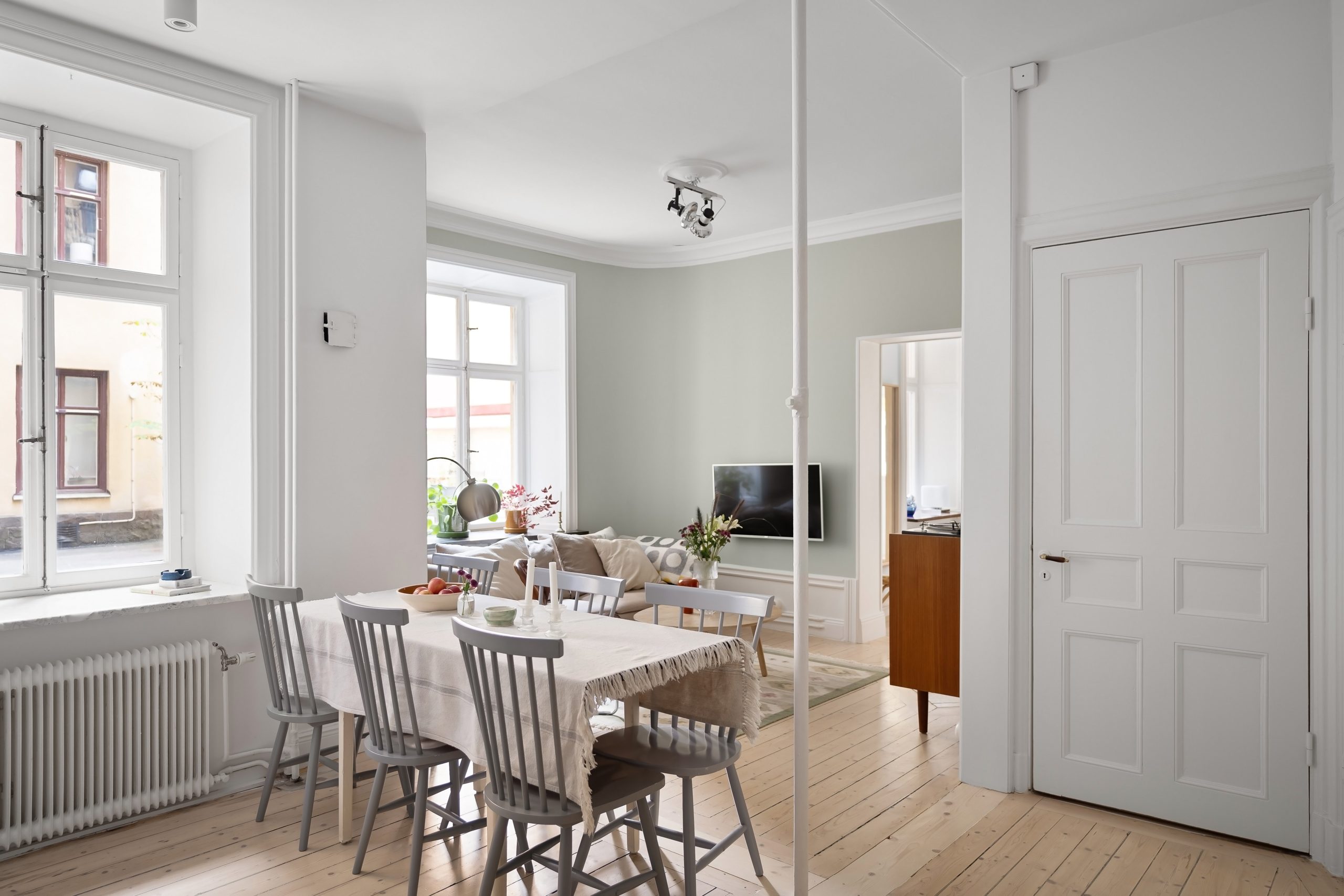 Spacious Scandinavian-style living and dining area with minimalist decor and natural light.