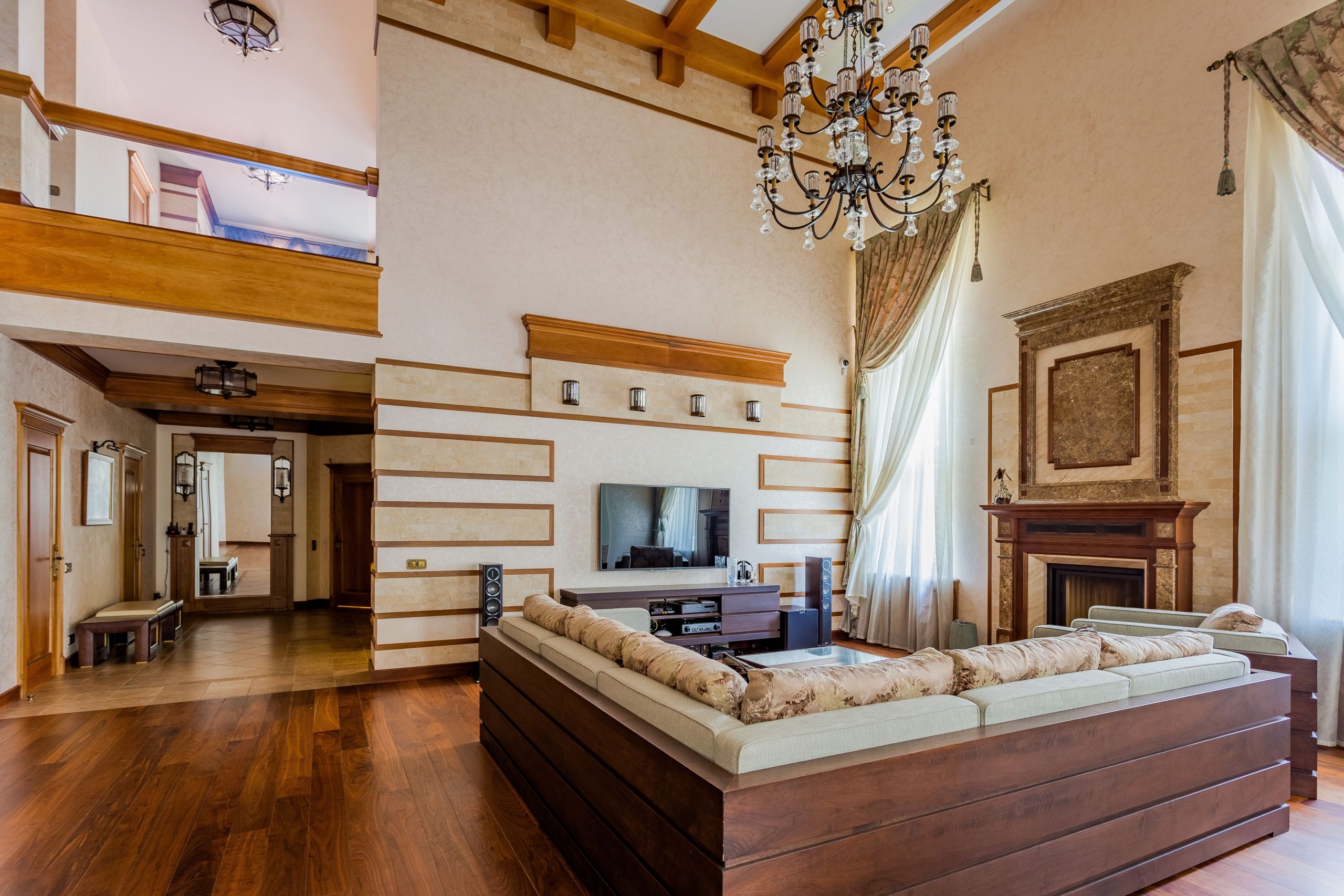 Spacious vintage living room with chandelier, fireplace, and modern decor elements.
