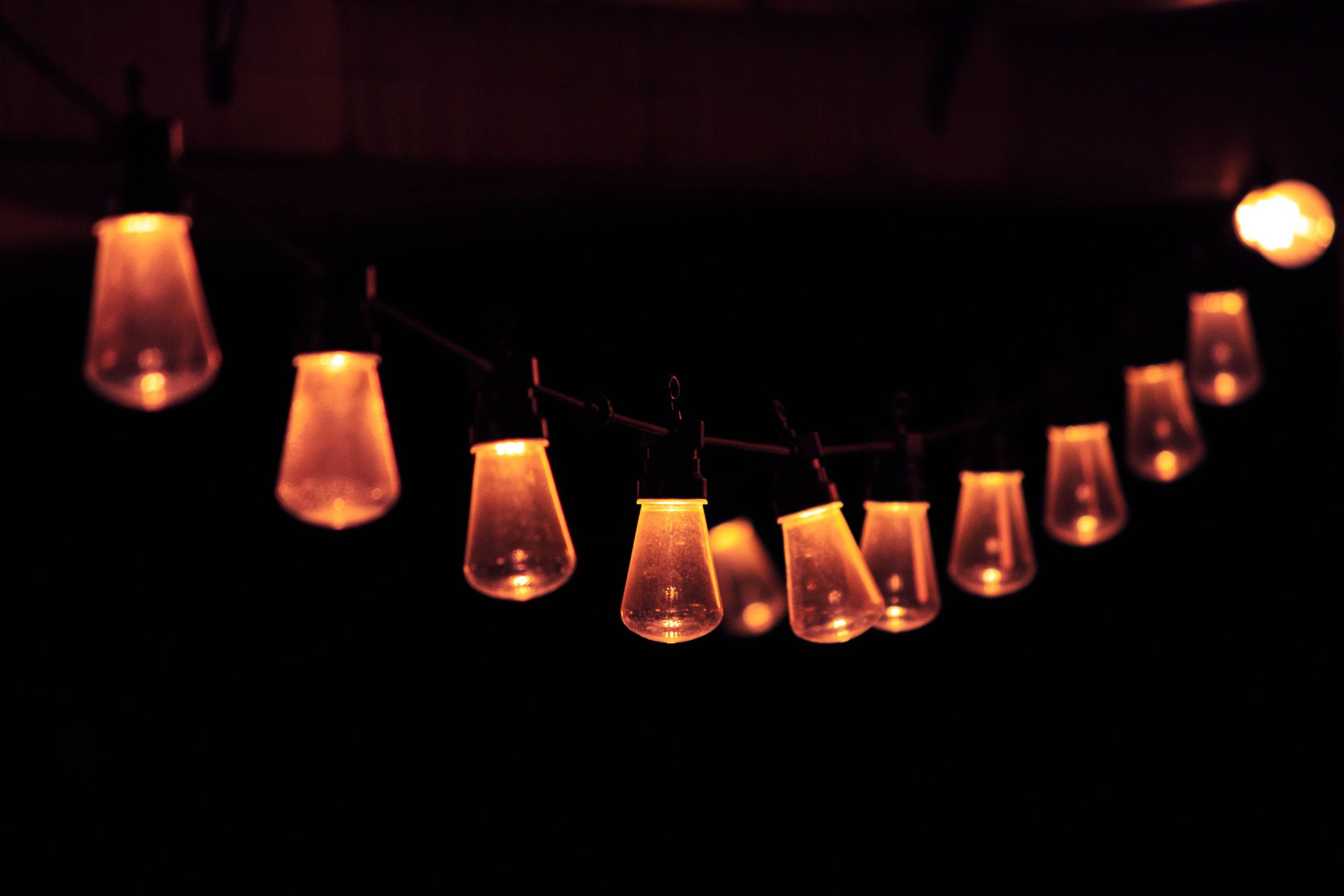 String of warm glowing lights in the dark, perfect for creating a cozy atmosphere.