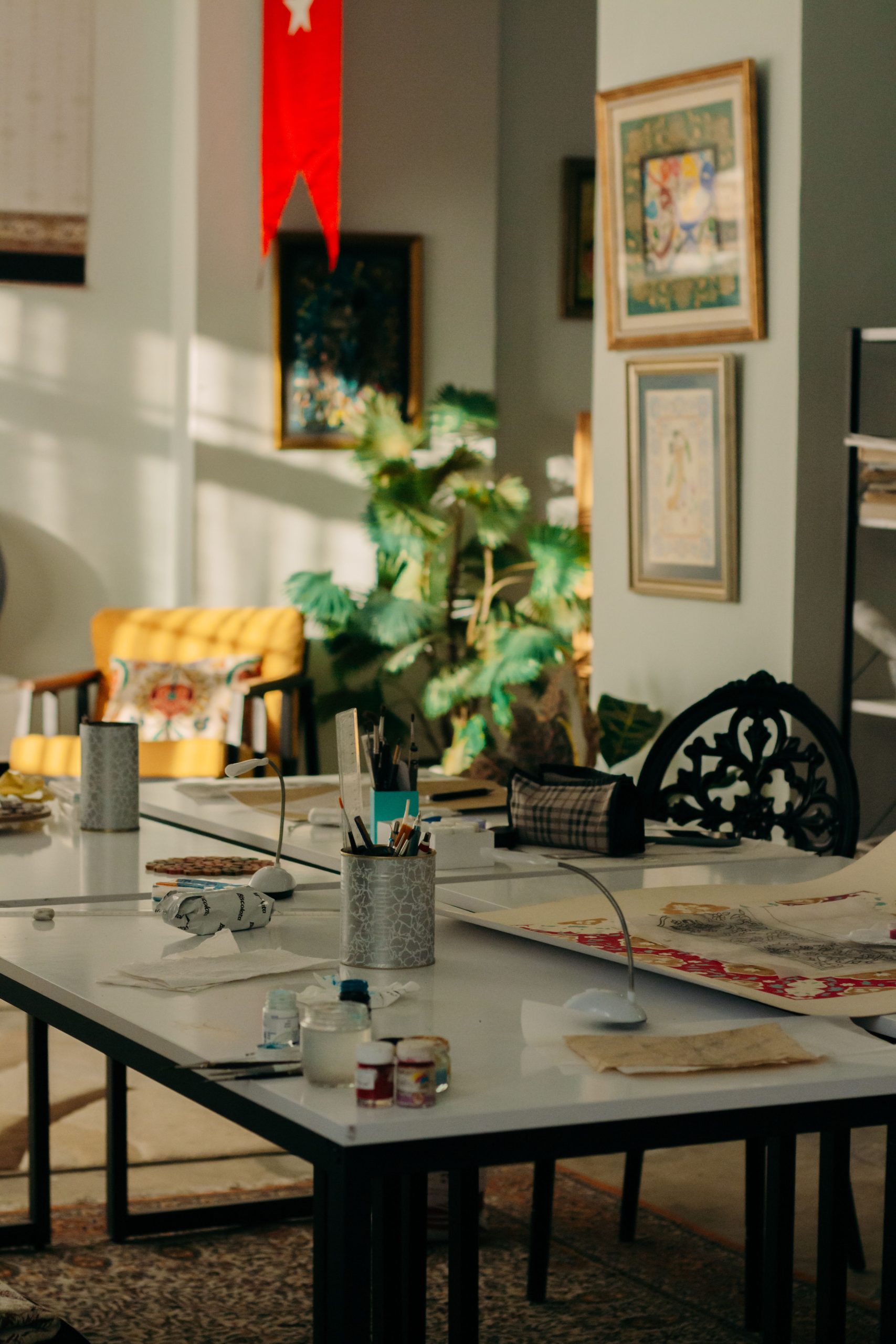 Sunlit art studio with supplies and decor, offering a creative ambiance.