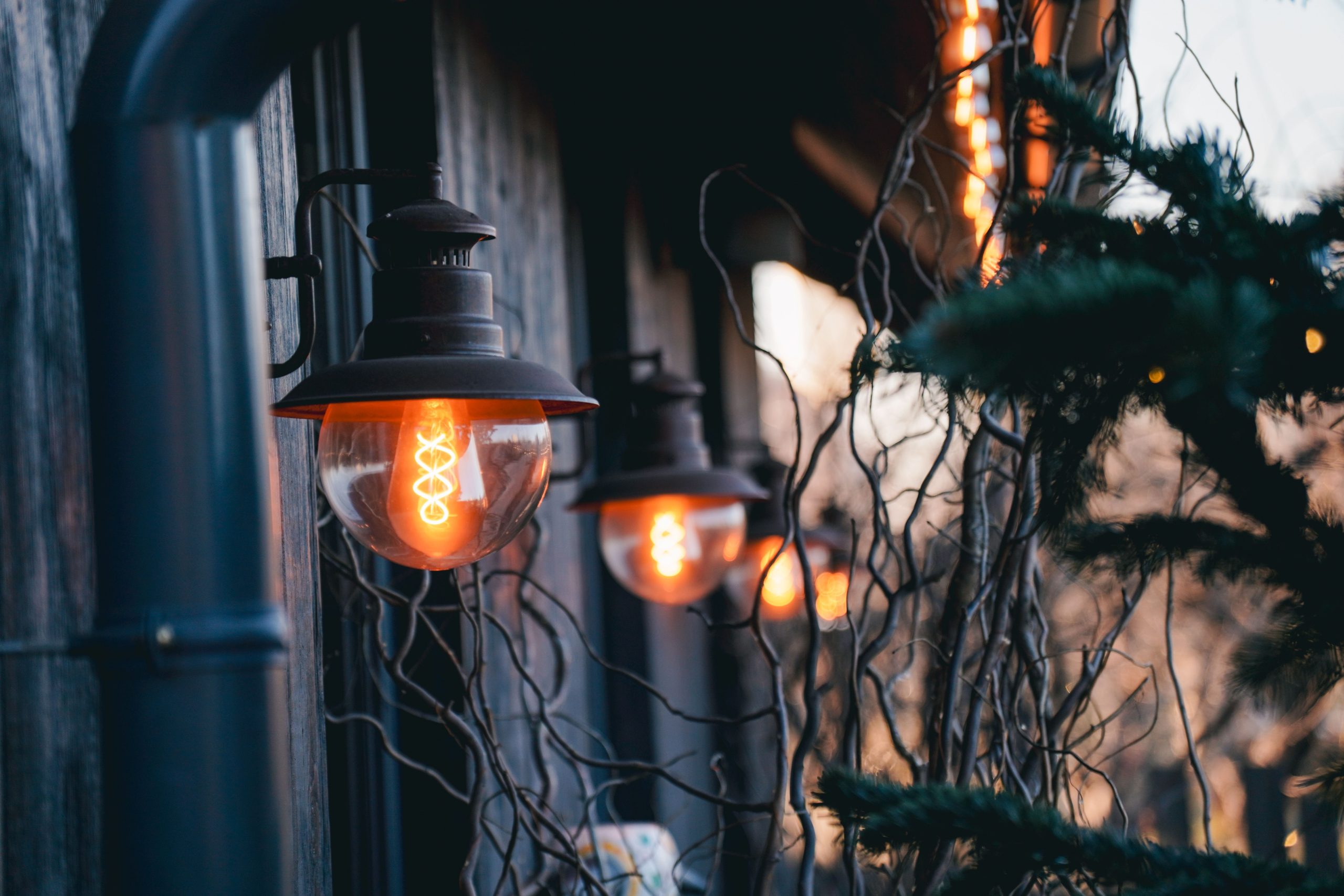 Warm glowing lamps illuminate a rustic exterior in Kyiv, Ukraine, creating a cozy atmosphere.