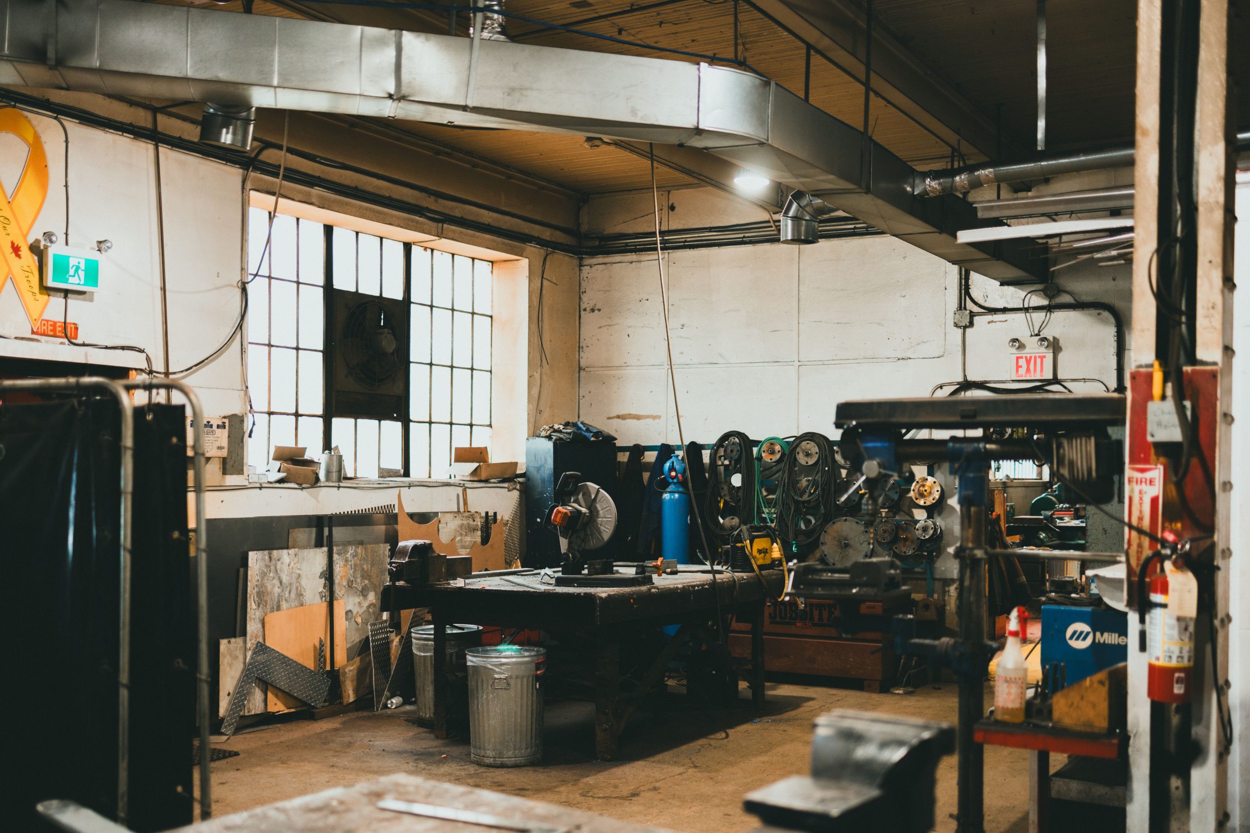 Warm-toned indoor industrial workshop with tools and equipment.