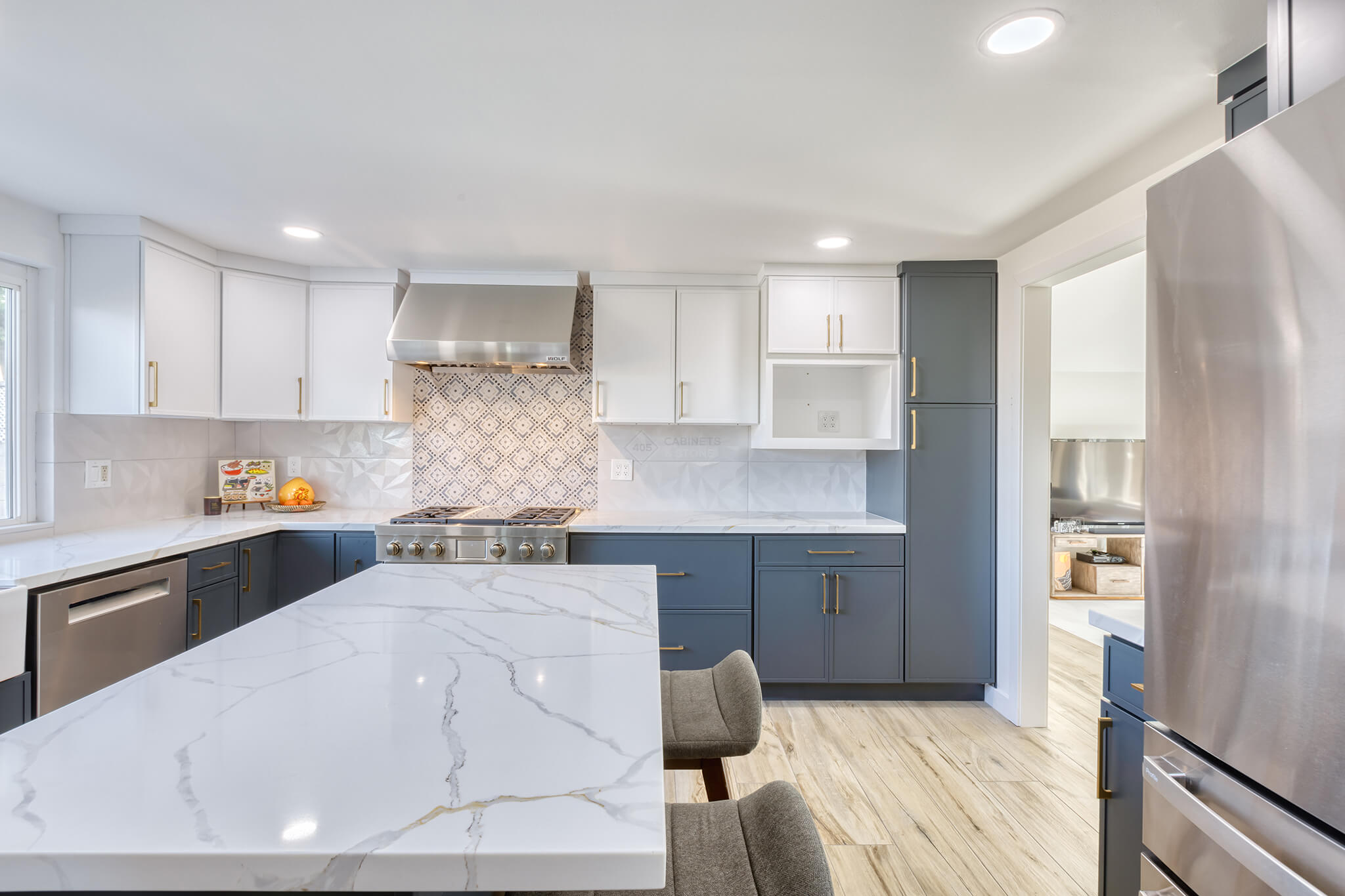 White and Navy Blue Kitchen Cabinets with Gold Hardware Accents