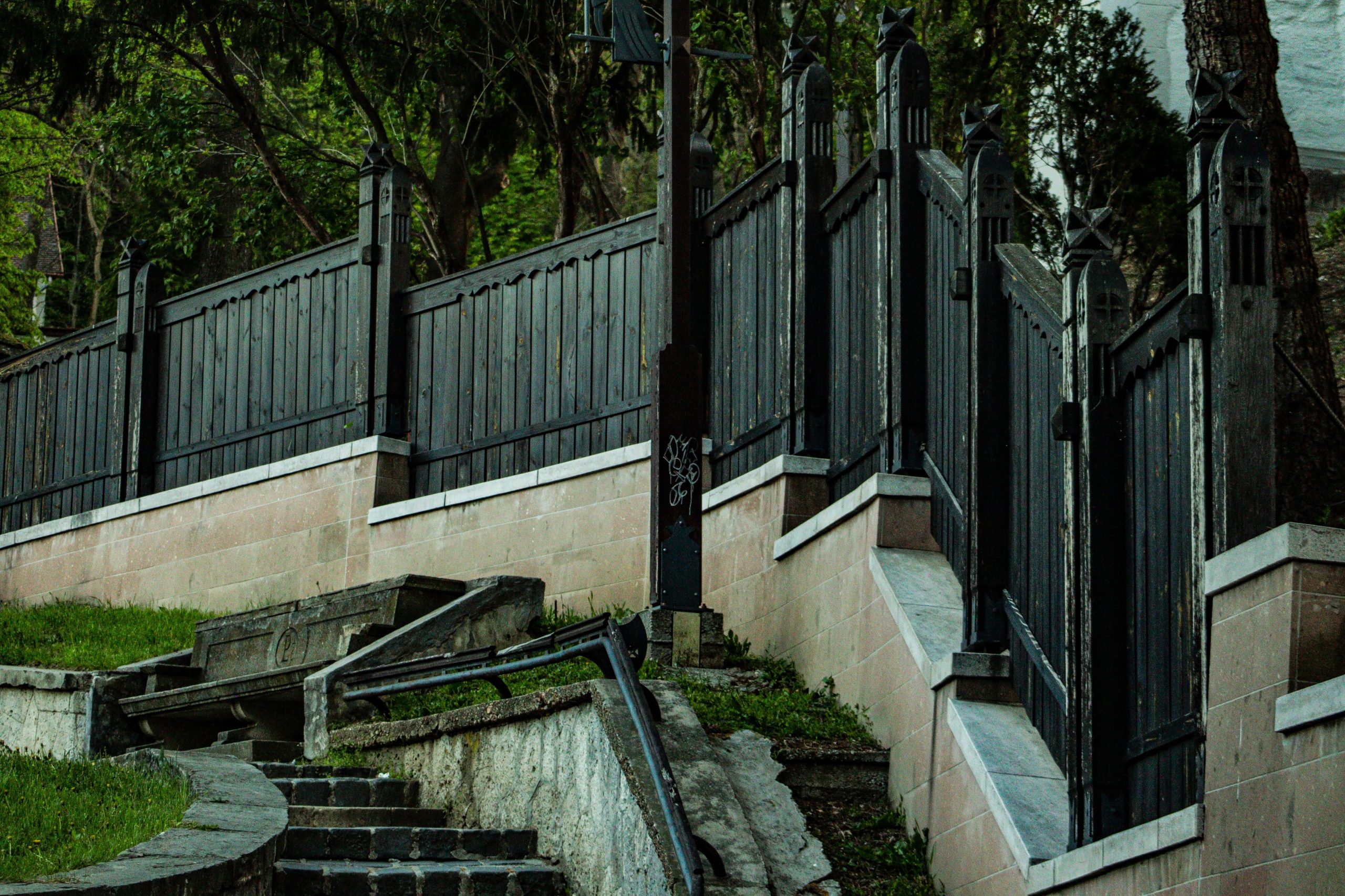Wooden fences and stone staircase in a lush, outdoor setting in Miskolc, Hungary.
